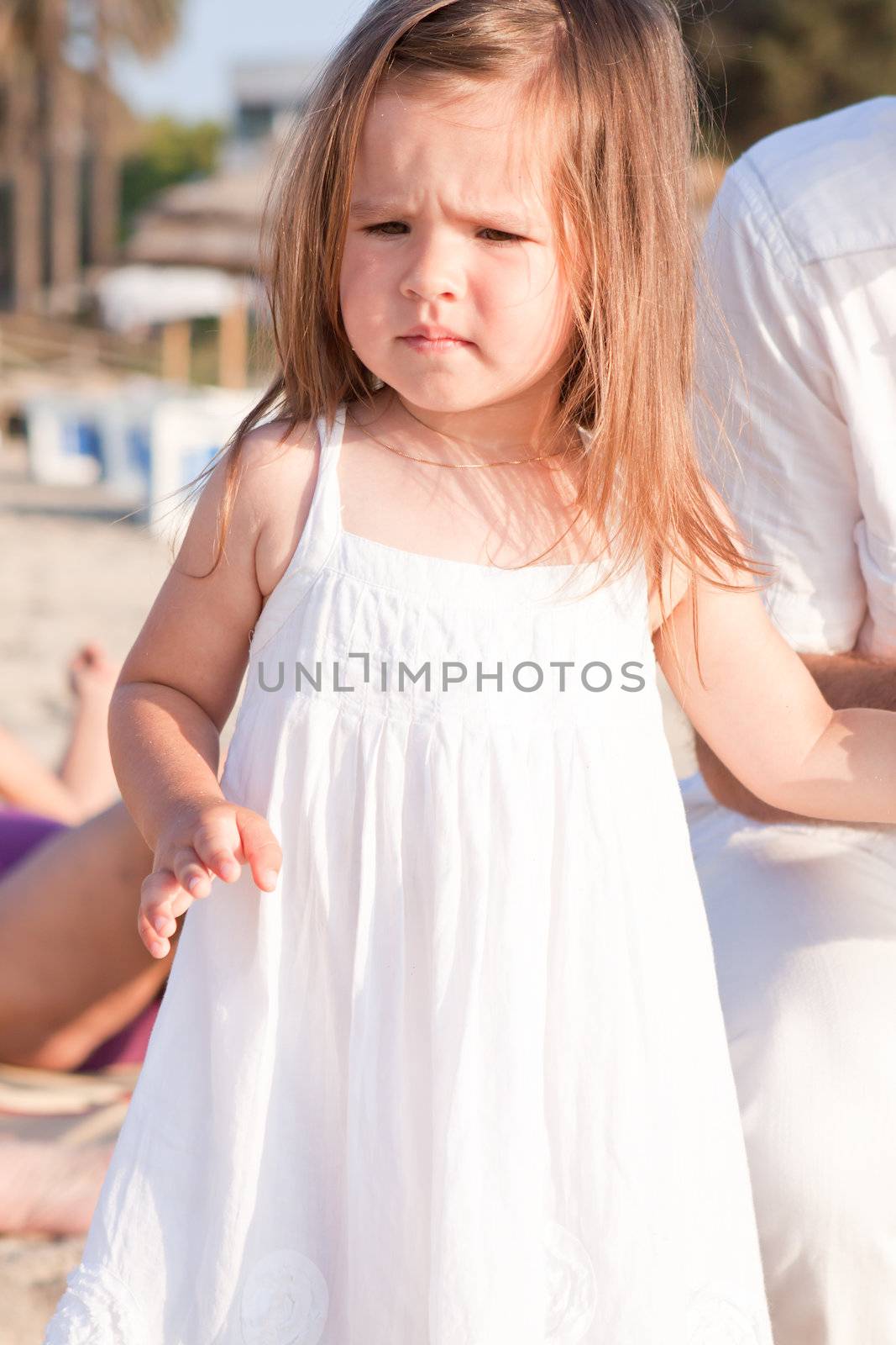little cute girl smiling playing on beach in summer vacation