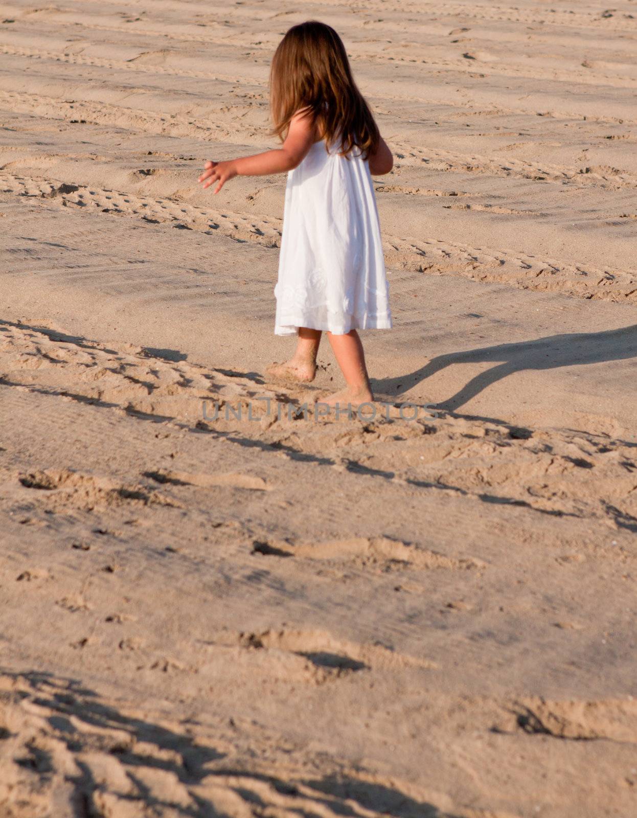 little cute girl smiling playing on beach in summer vacation