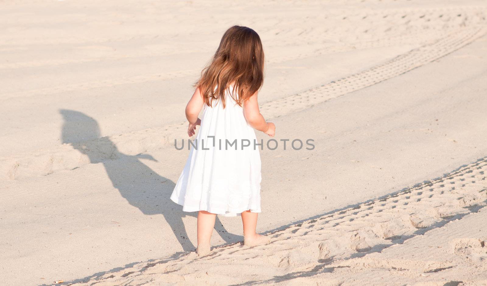 little cute girl smiling playing on beach in summer by juniart