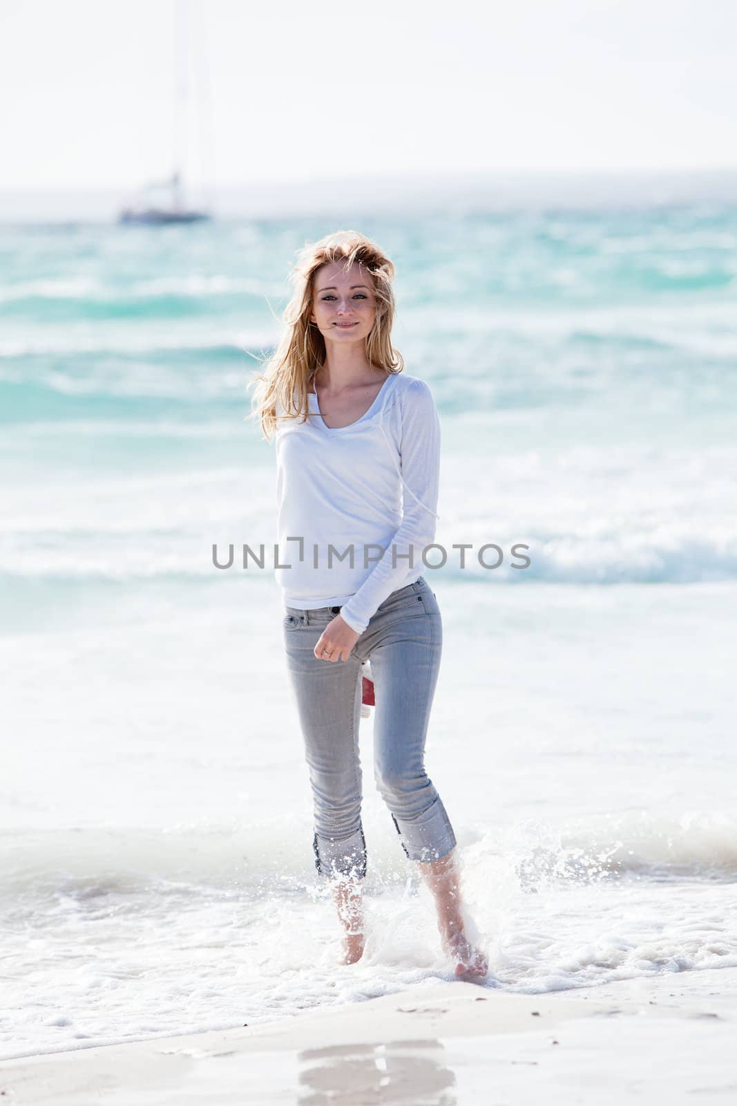 beautiful young woman walking on beach in summer vacation relaxing
