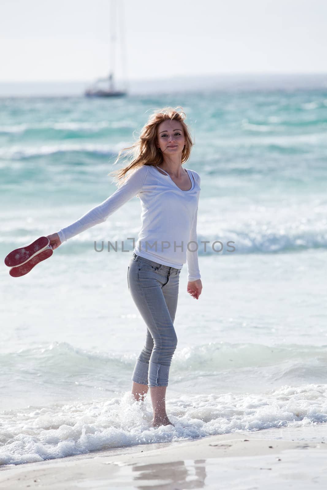 beautiful young woman walking on beach in summer vacation relaxing