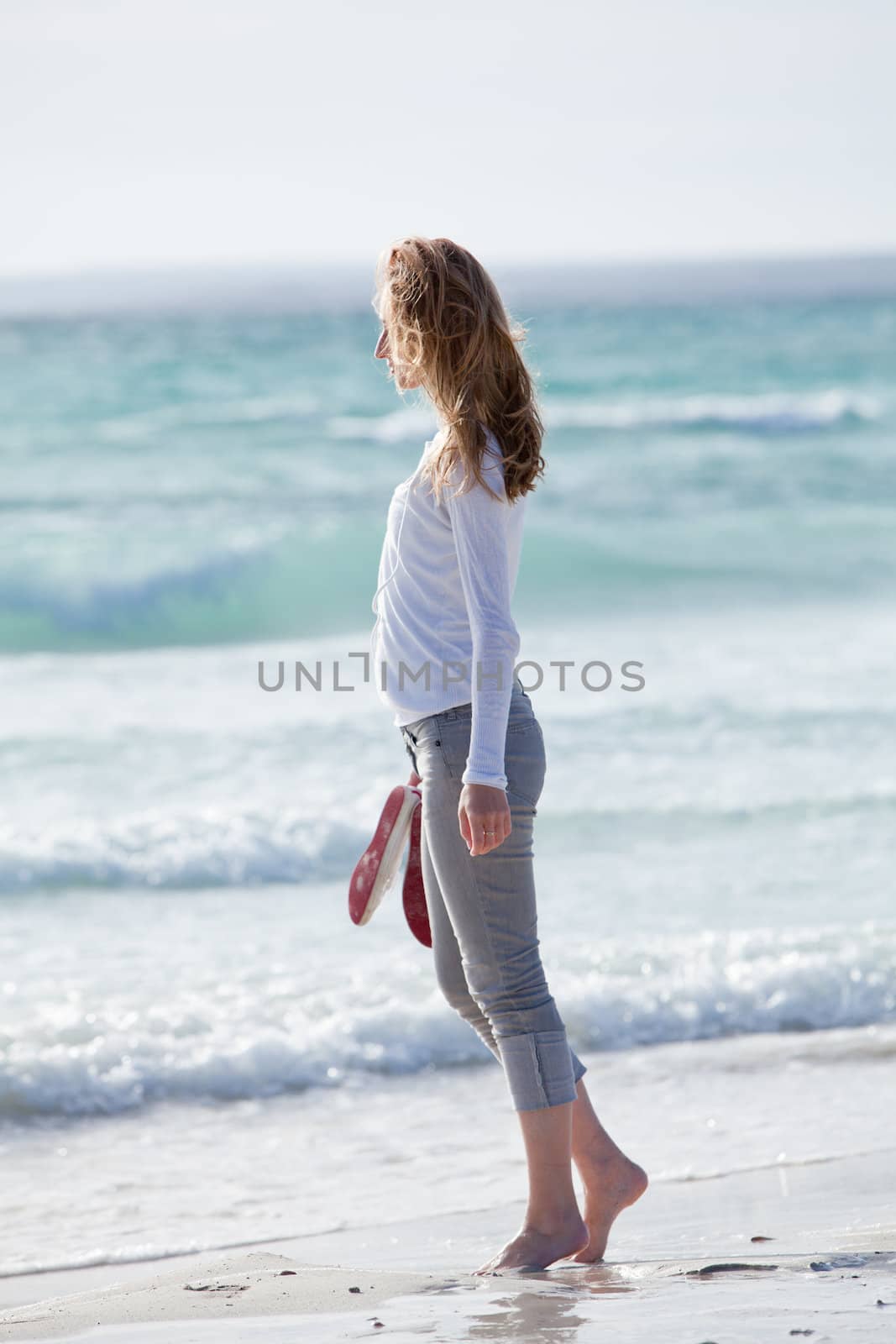 beautiful young woman walking on beach in summer vacation relaxing