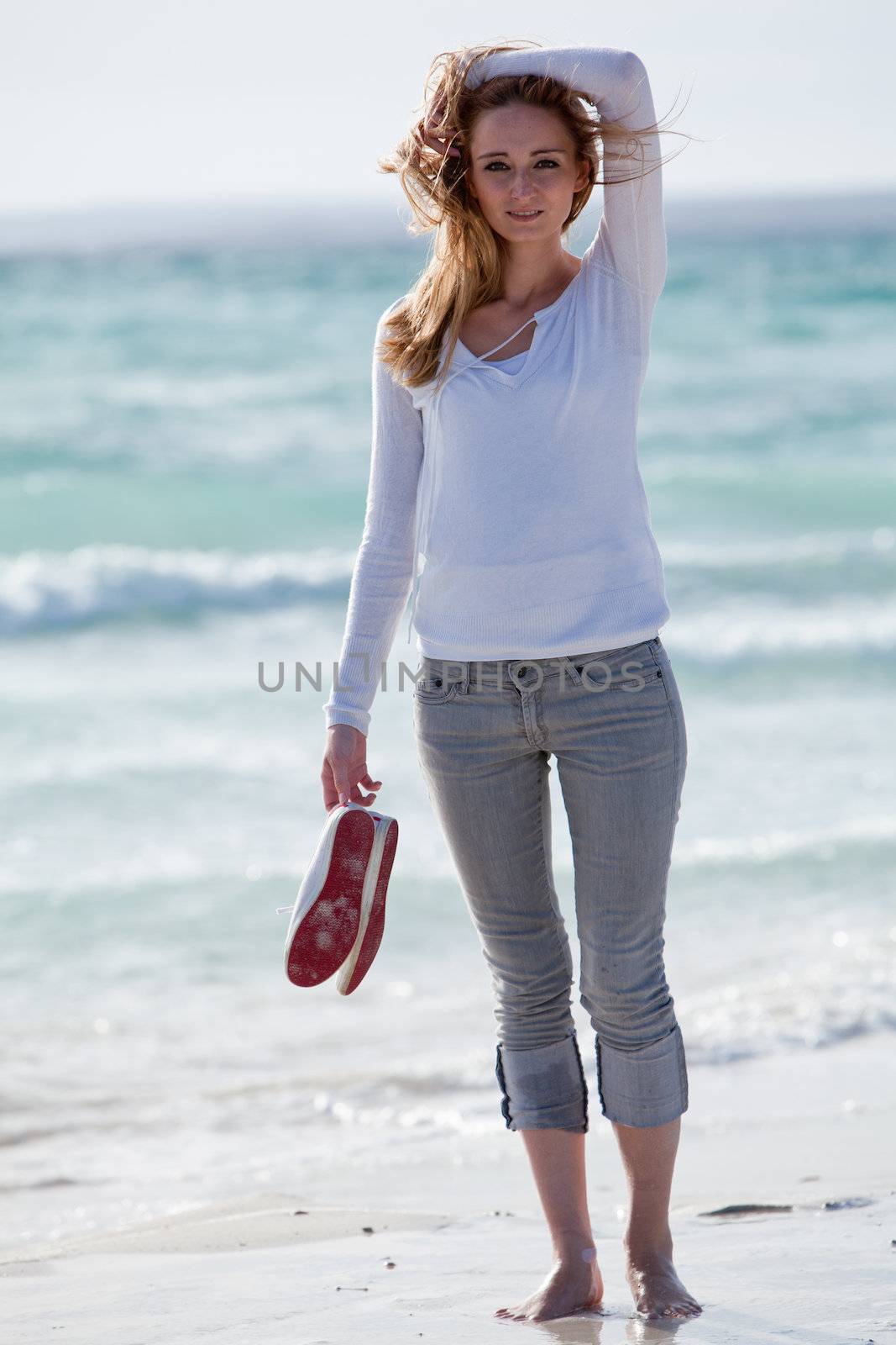beautiful young woman walking on beach in summer vacation relaxing