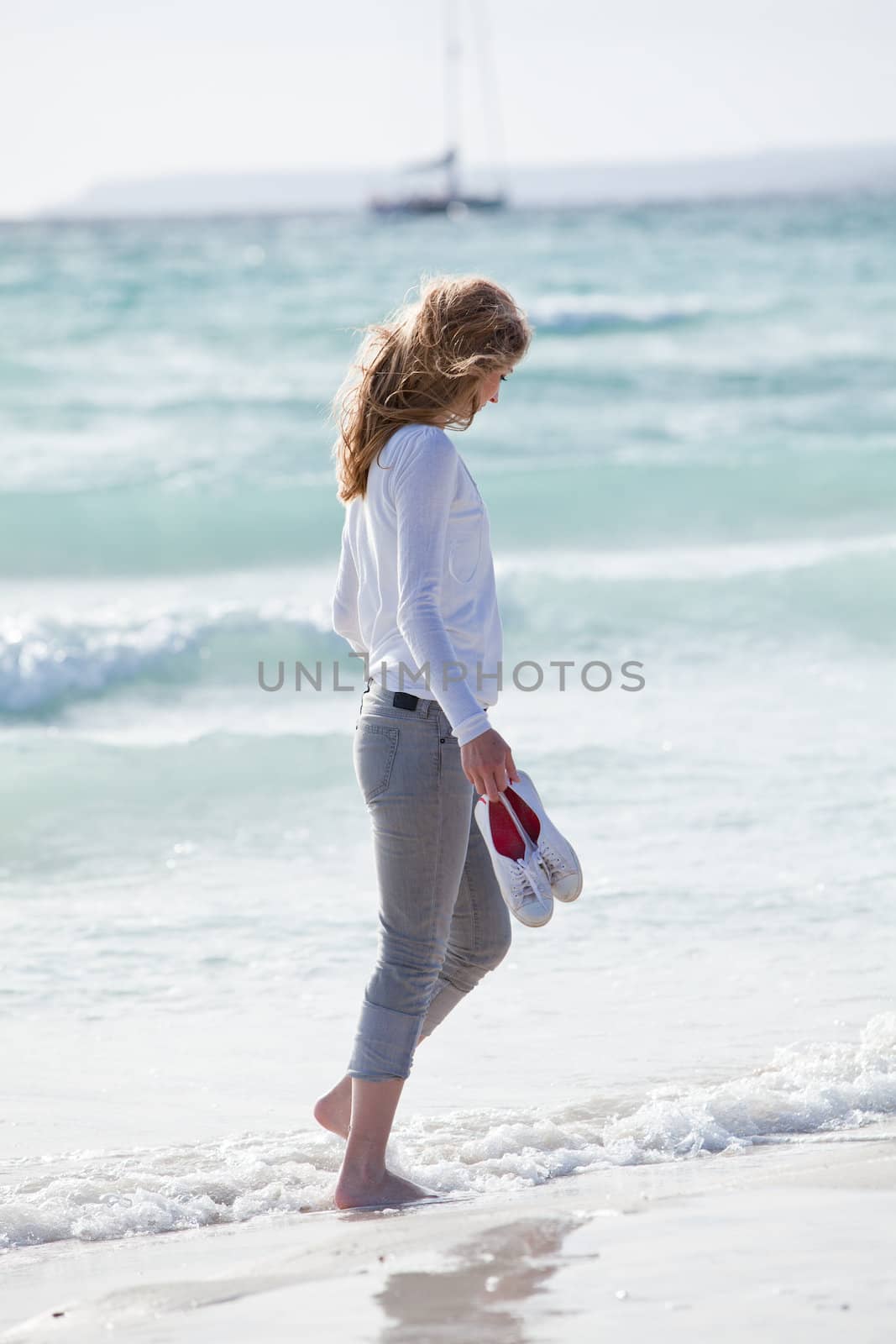 beautiful young woman walking on beach in summer vacation relaxing