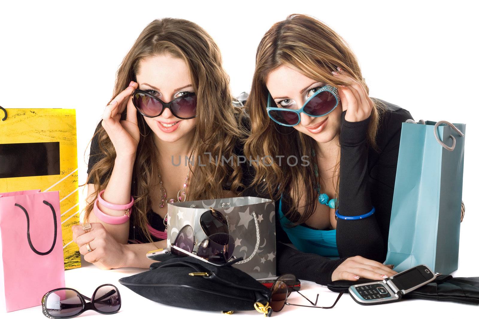 Two smiling beautiful girlfriends in sunglasses after shopping