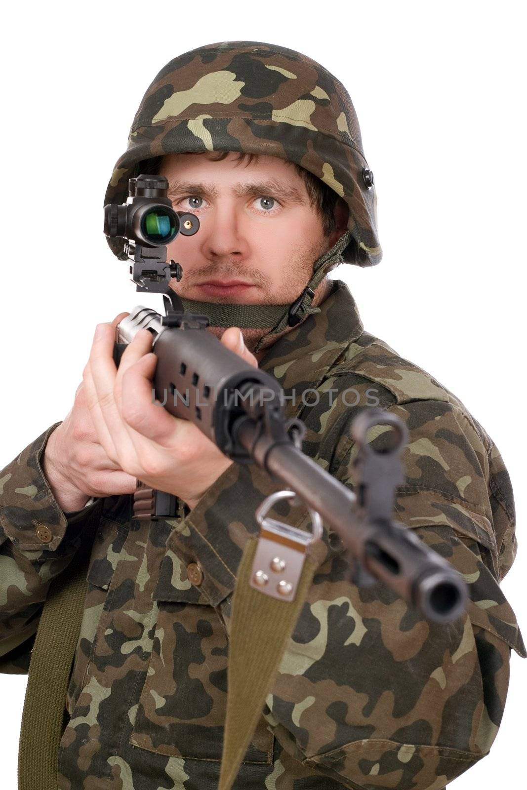 Soldier keeping a rifle in studio. Isolated