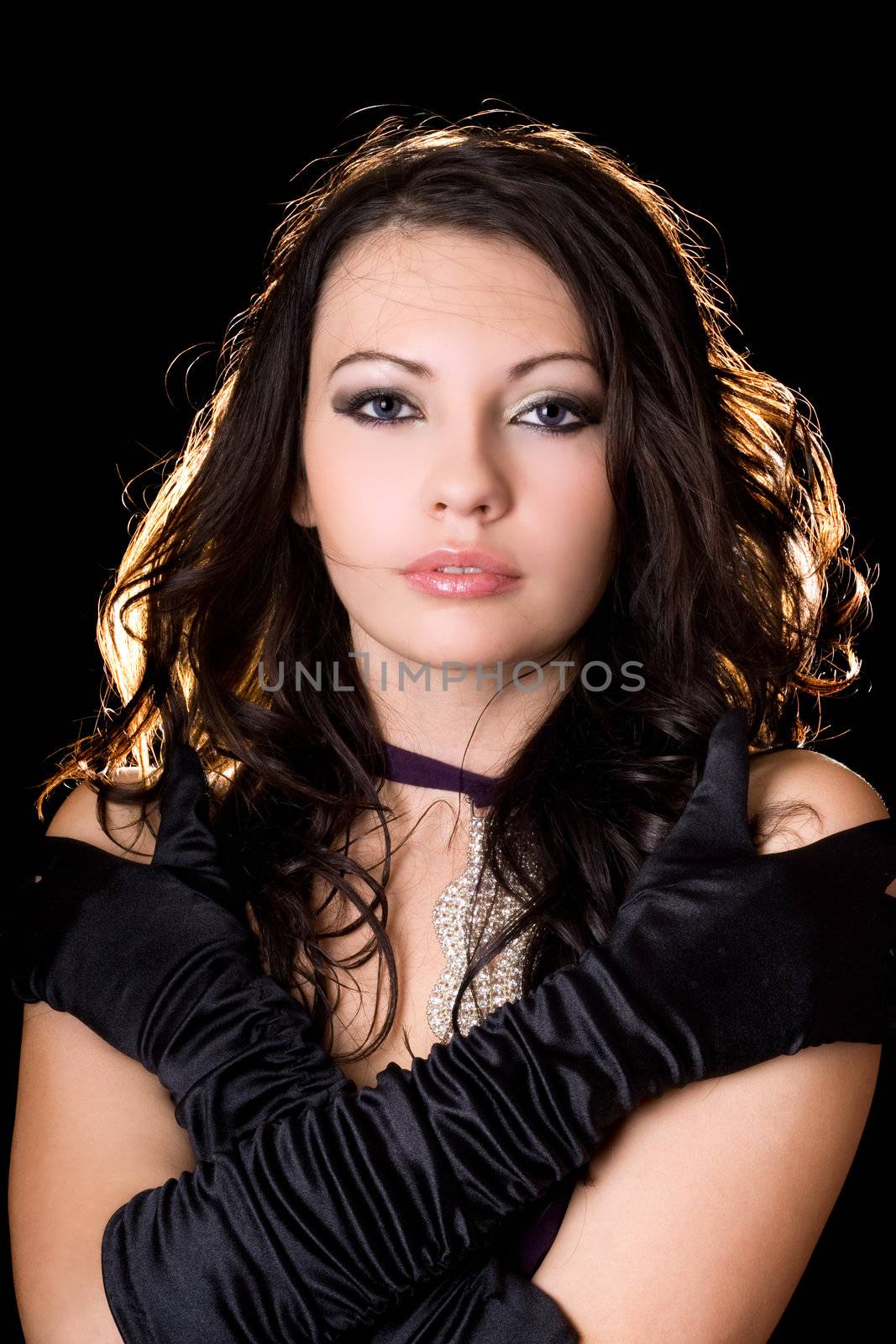 Portrait of the young woman over black