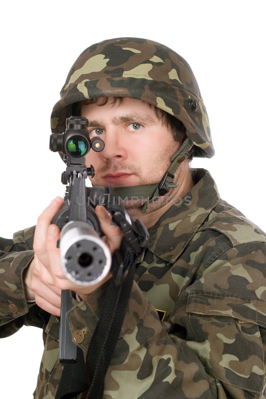 Armed soldier aiming m16 in studio. Isolated
