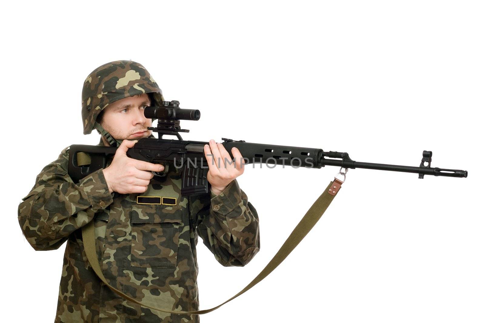 Soldier holding a rifle in studio. Isolated
