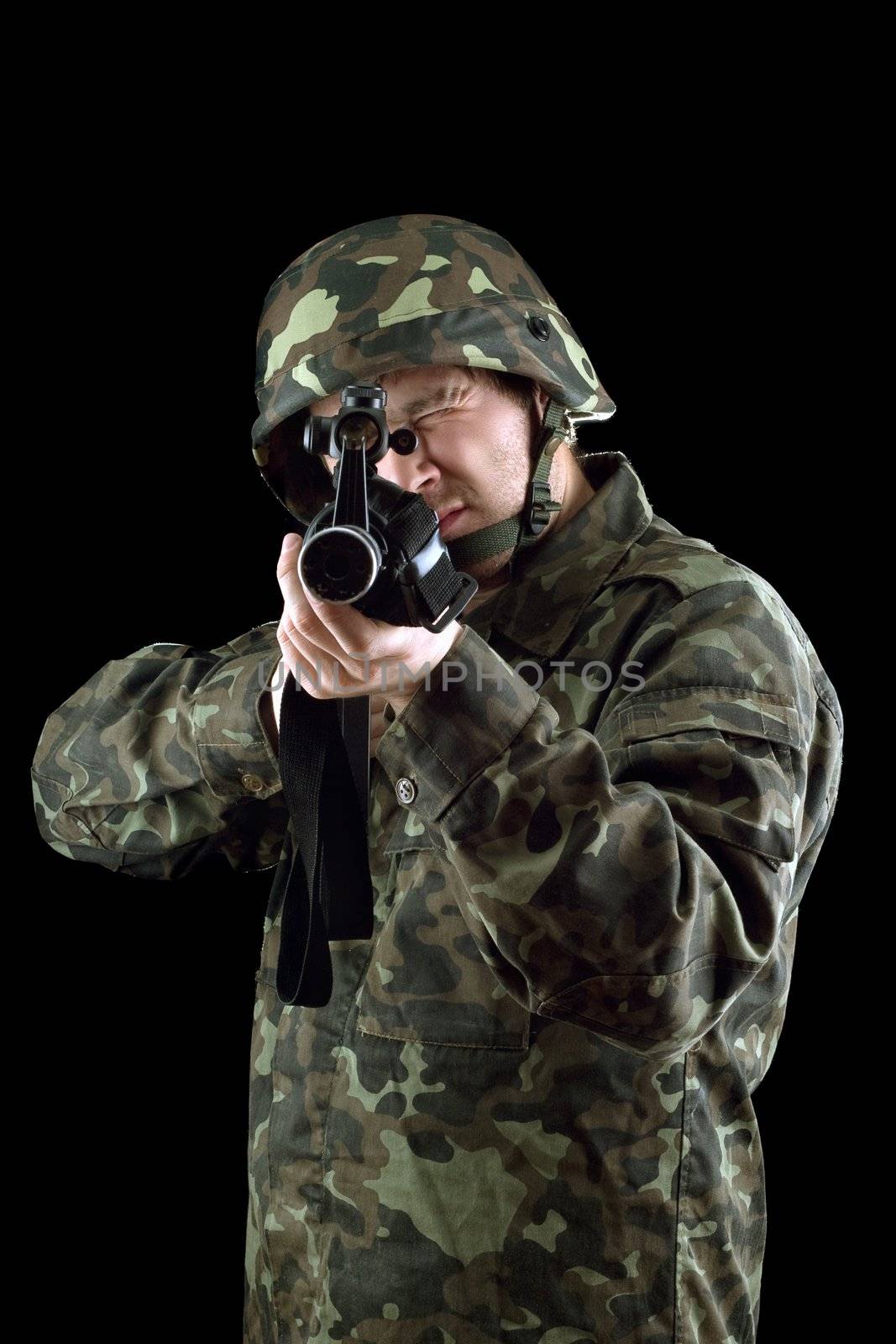 Armed man pointing a gun in studio