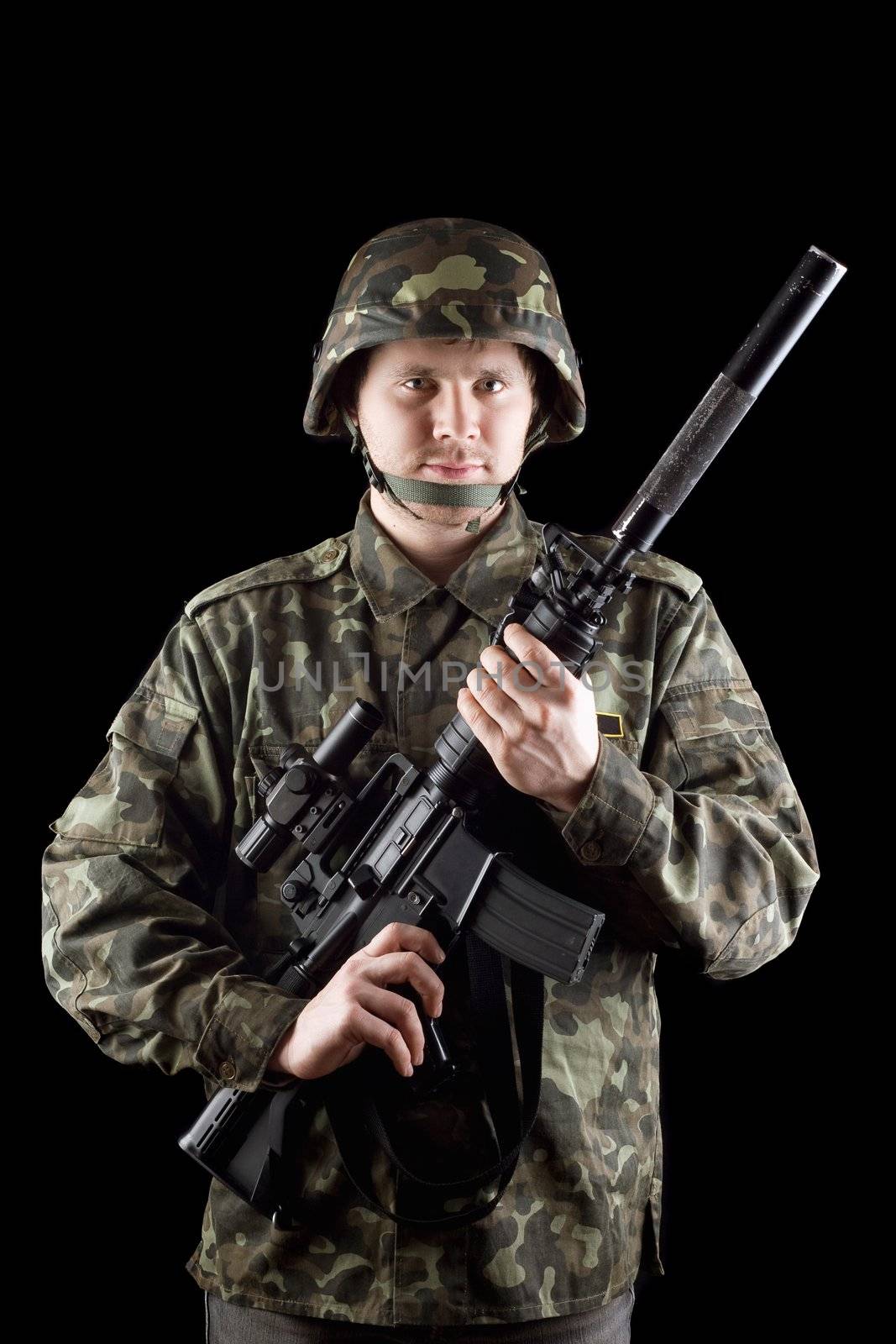 Soldier staying with m16 in studio. Isolated