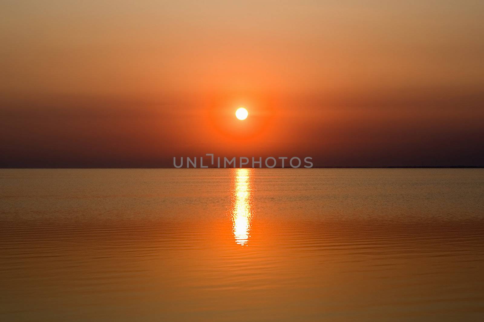 Calm sea bay at the red sunset