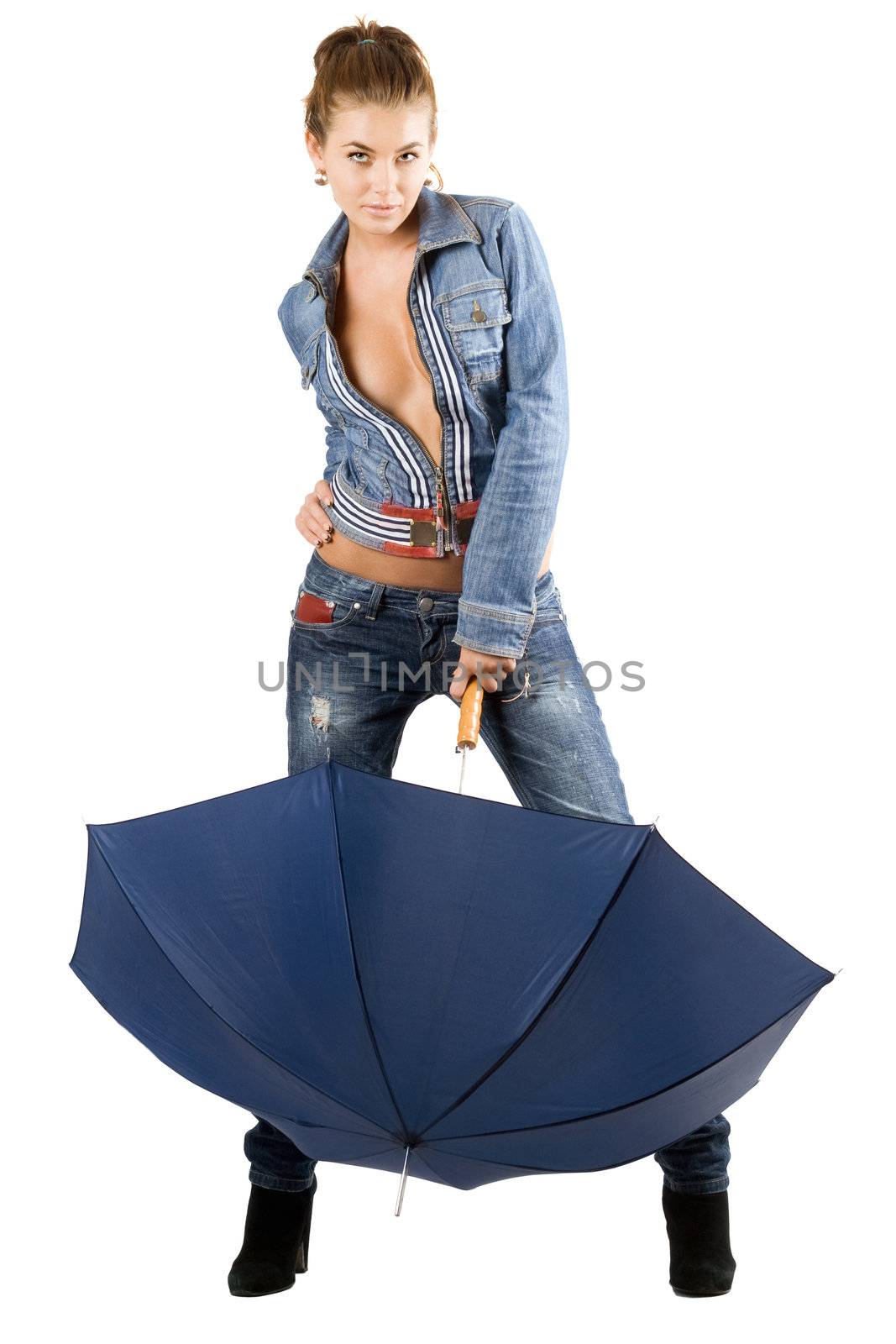 Playful young woman in a blue denim suit with umbrella