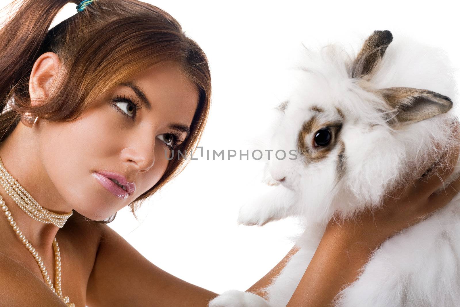 Young woman playing with little rabbit. Focus on girl