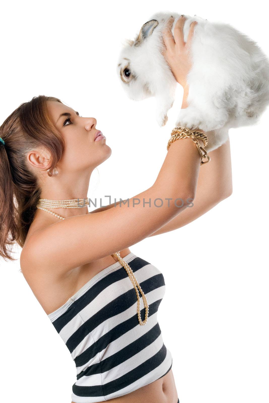 Pretty young woman playing with rabbit. Isolated