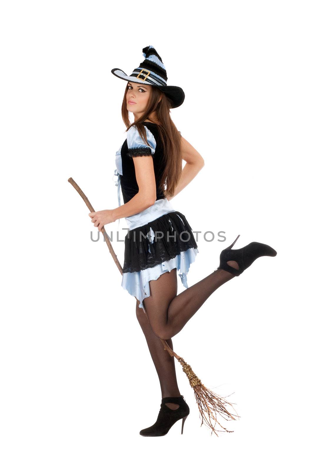 Playful beautiful young woman with a besom wearing costume witch