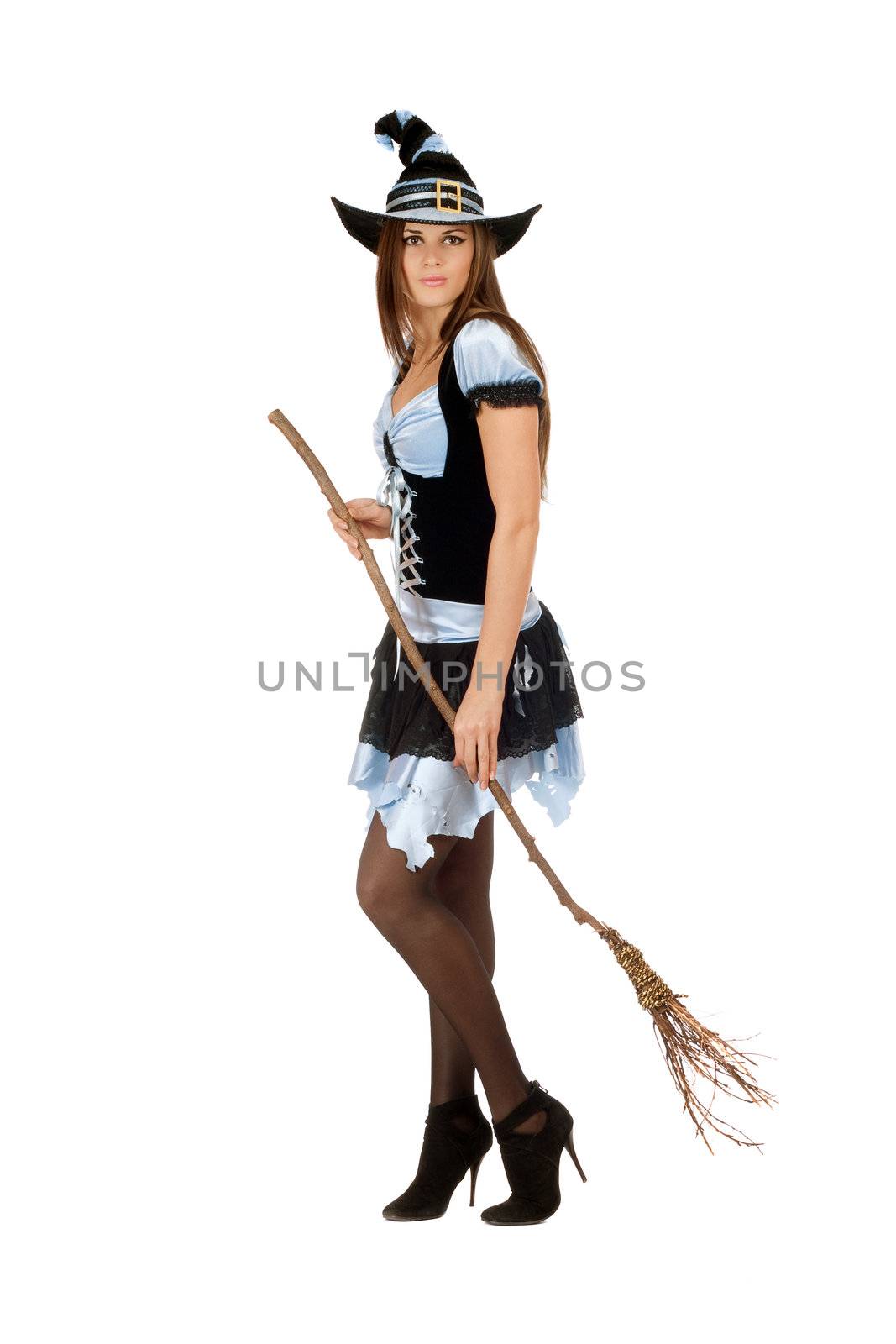 Pretty young woman with a besom wearing costume witch