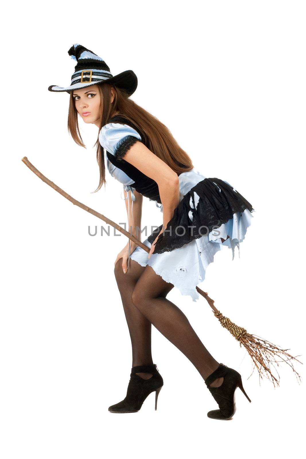 Beautiful young woman with a besom wearing costume witch