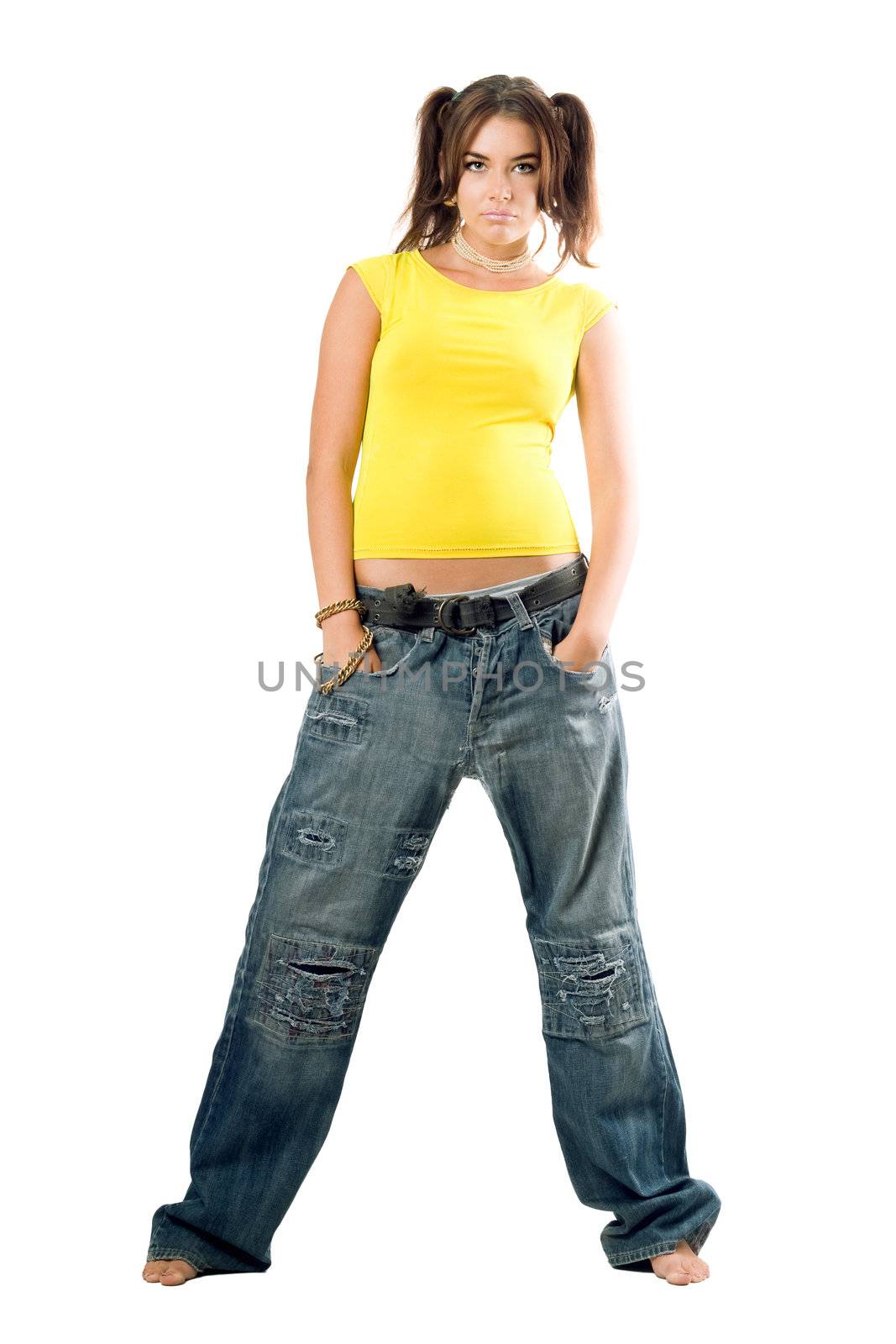 Young rapper girl in wide jeans and yellow top. Isolated