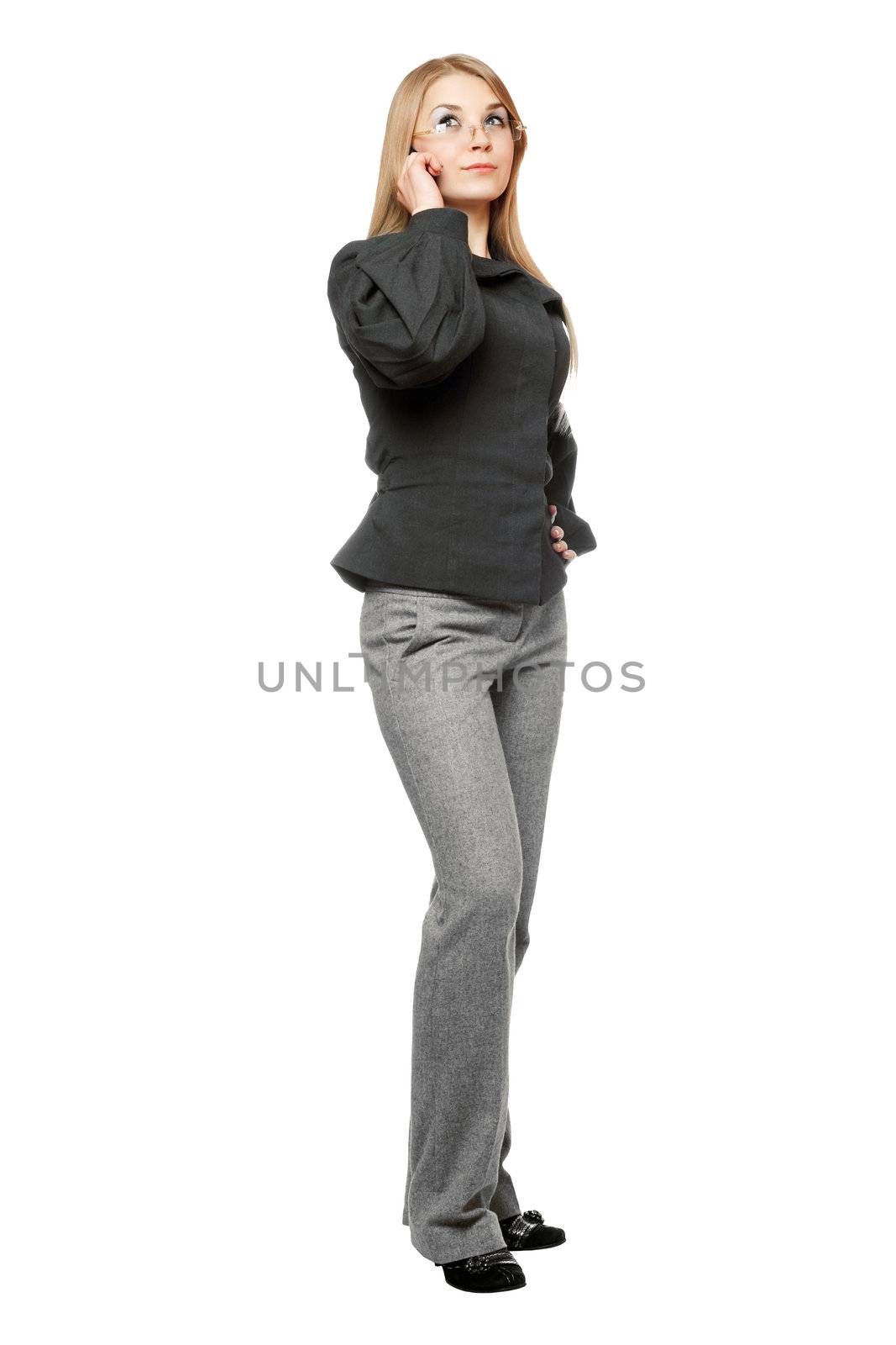 Serious young woman in a gray business suit talking on the phone