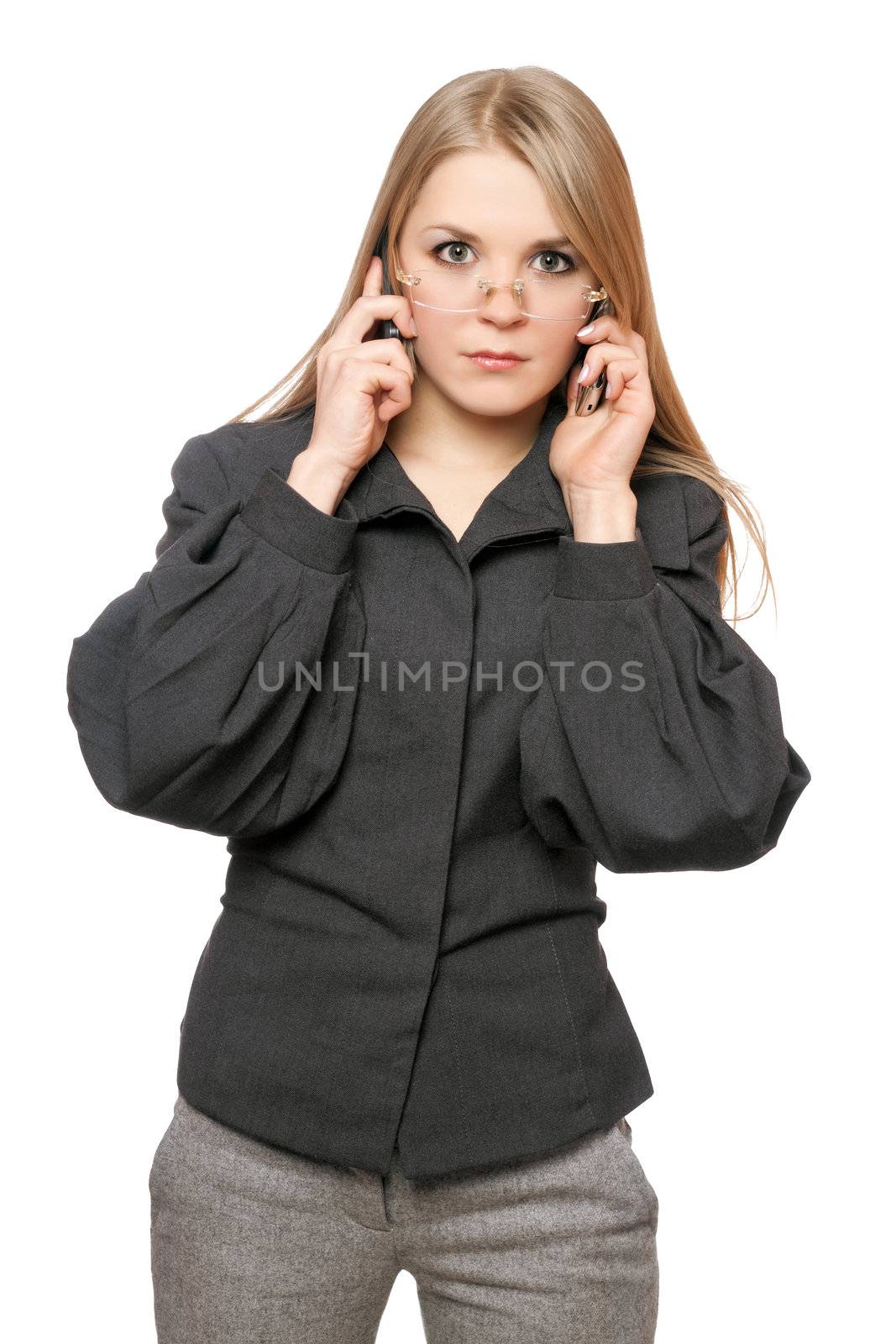 Portrait of serious young blonde in a gray business suit with two phones