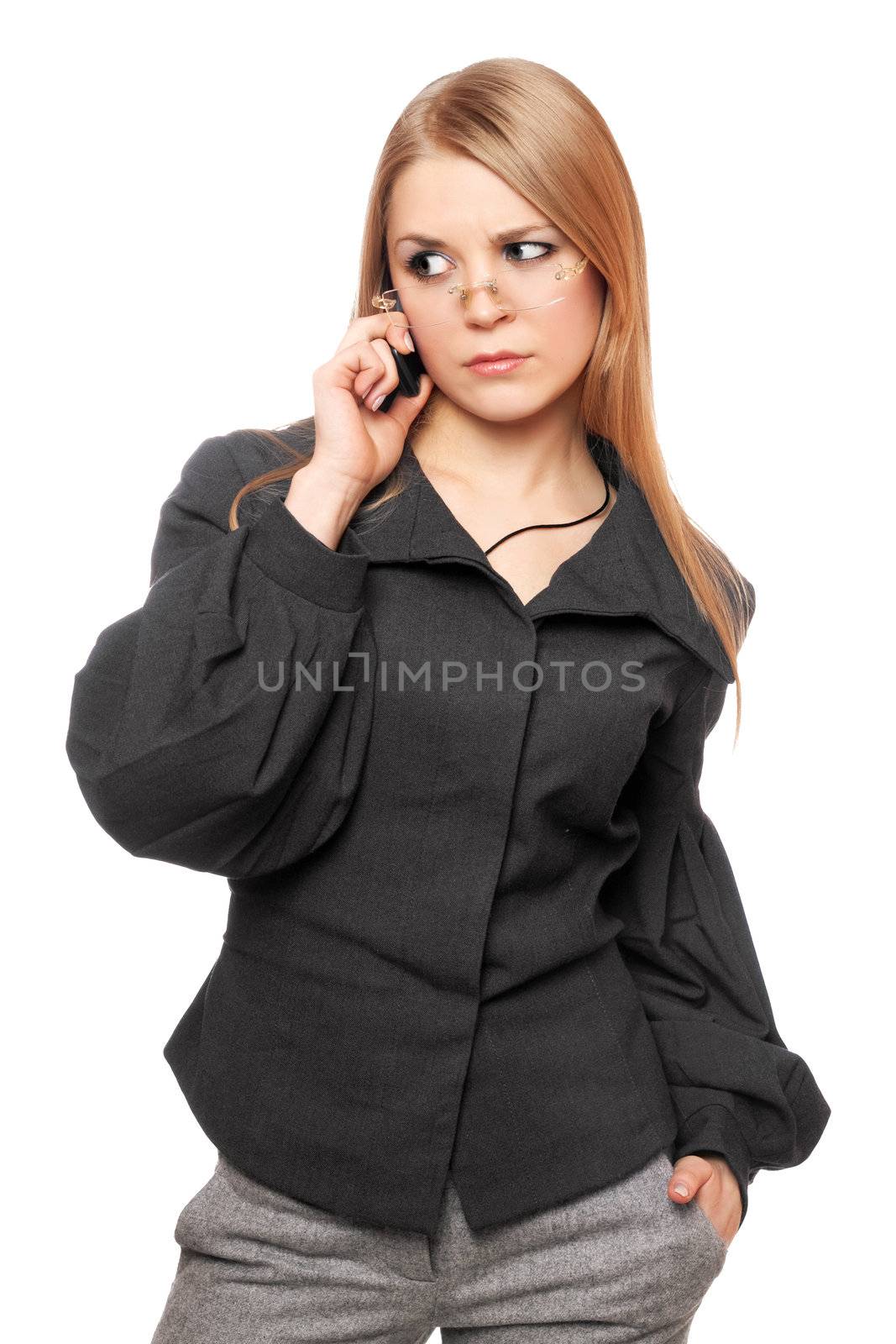 Portrait of dissatisfied young blonde in a gray business suit with the phone