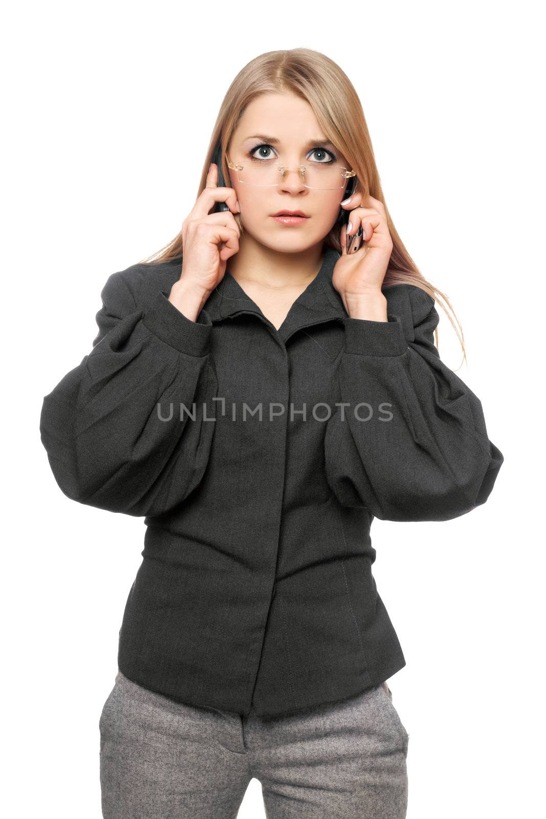 Portrait of tired young blonde in a gray business suit with two phones