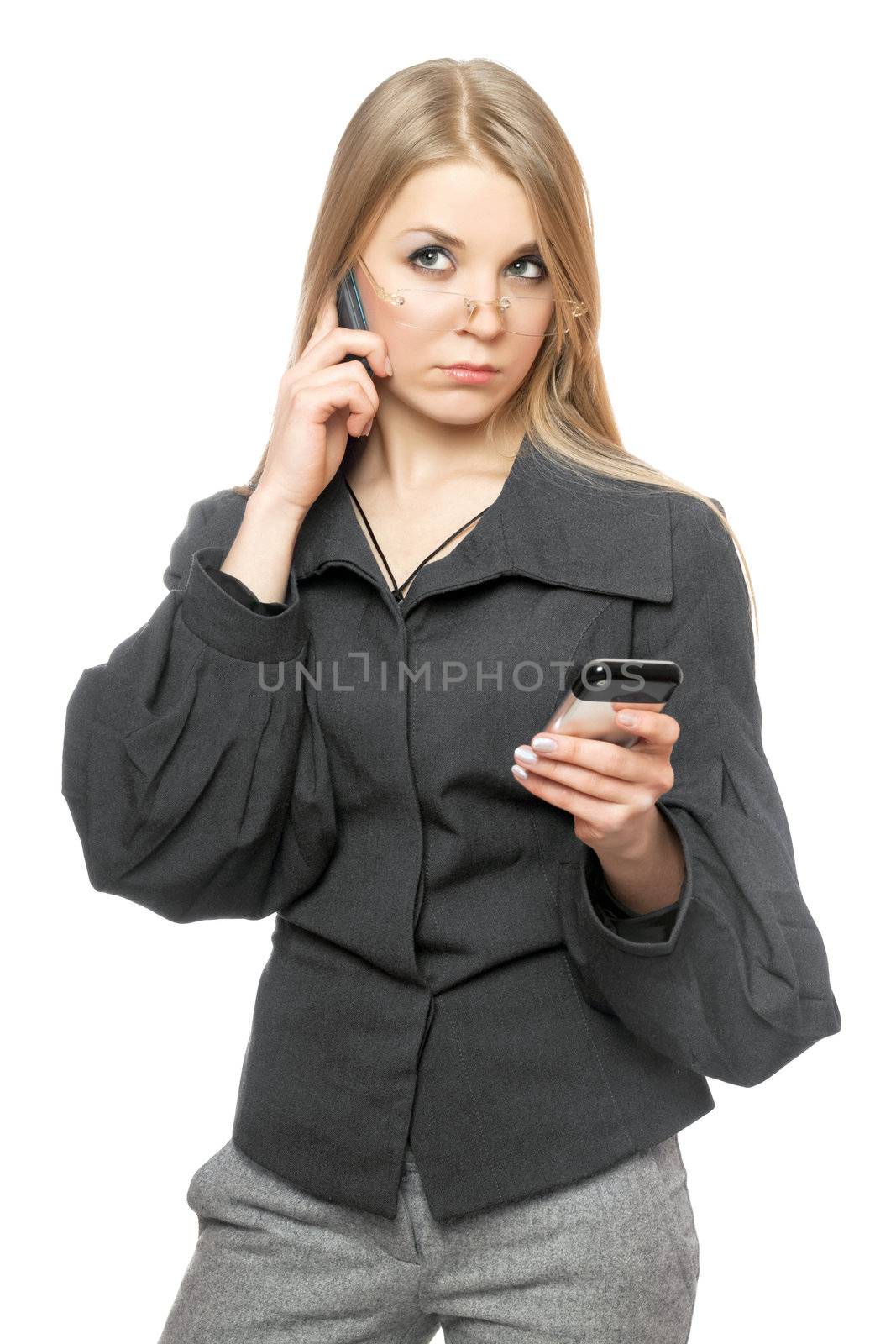 Portrait of thoughtful young blonde in a gray business suit with two phones