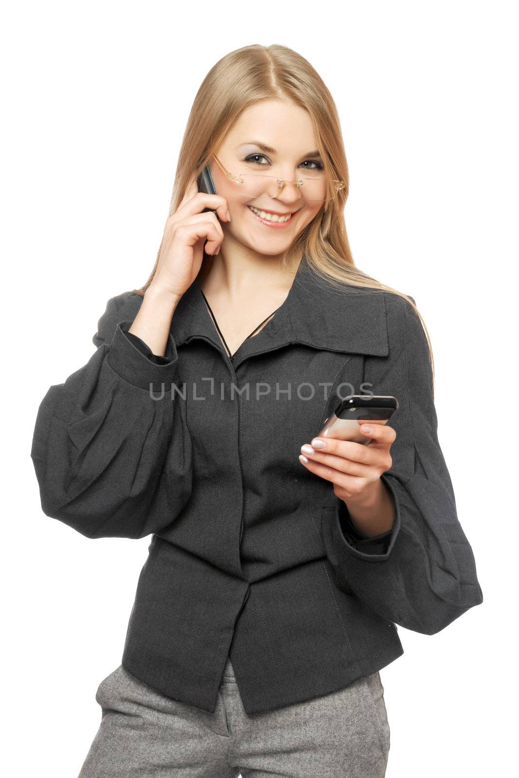 Smiling young blonde in a gray business suit with two phones