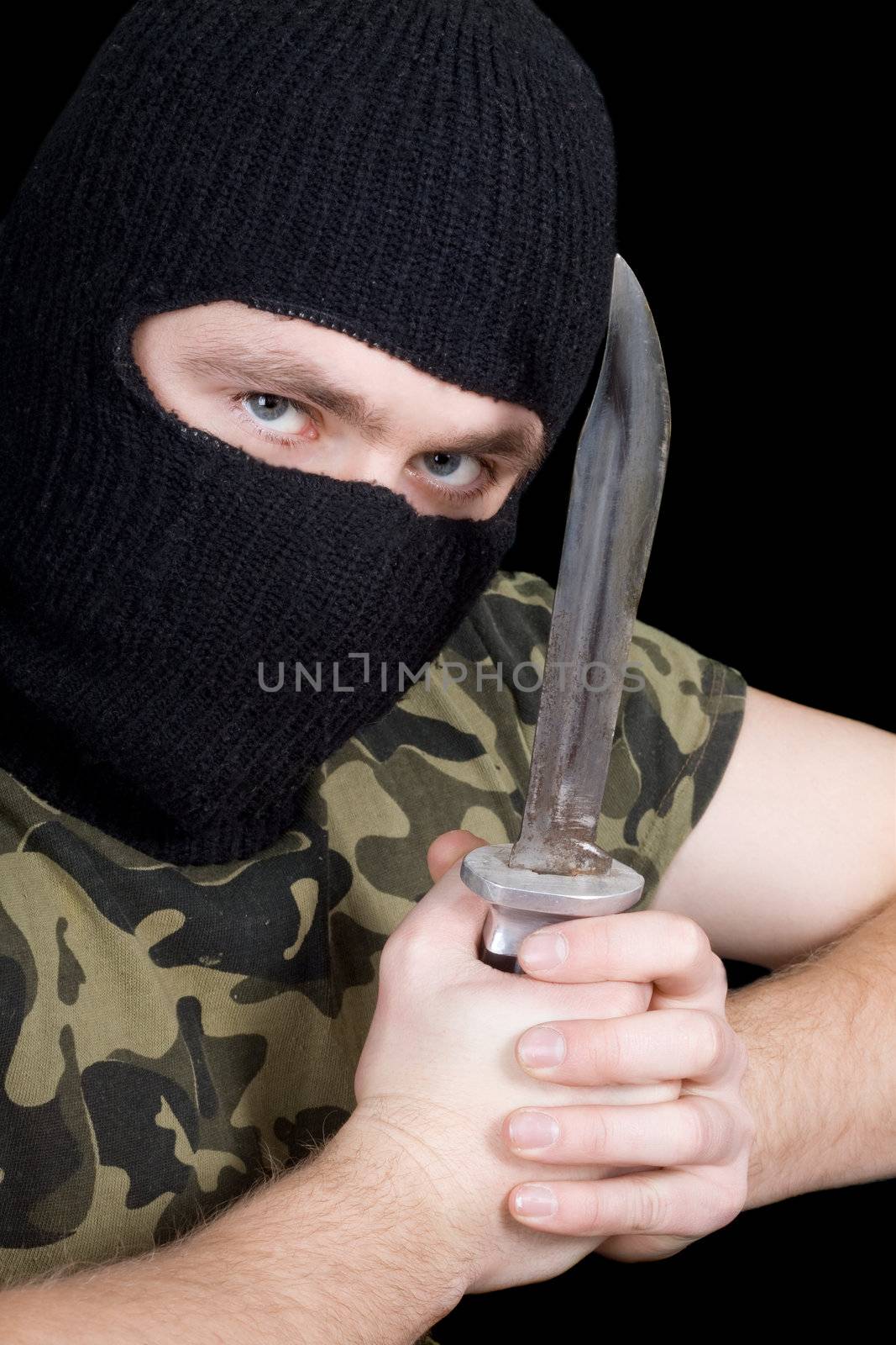 The murderer with a knife in a black mask