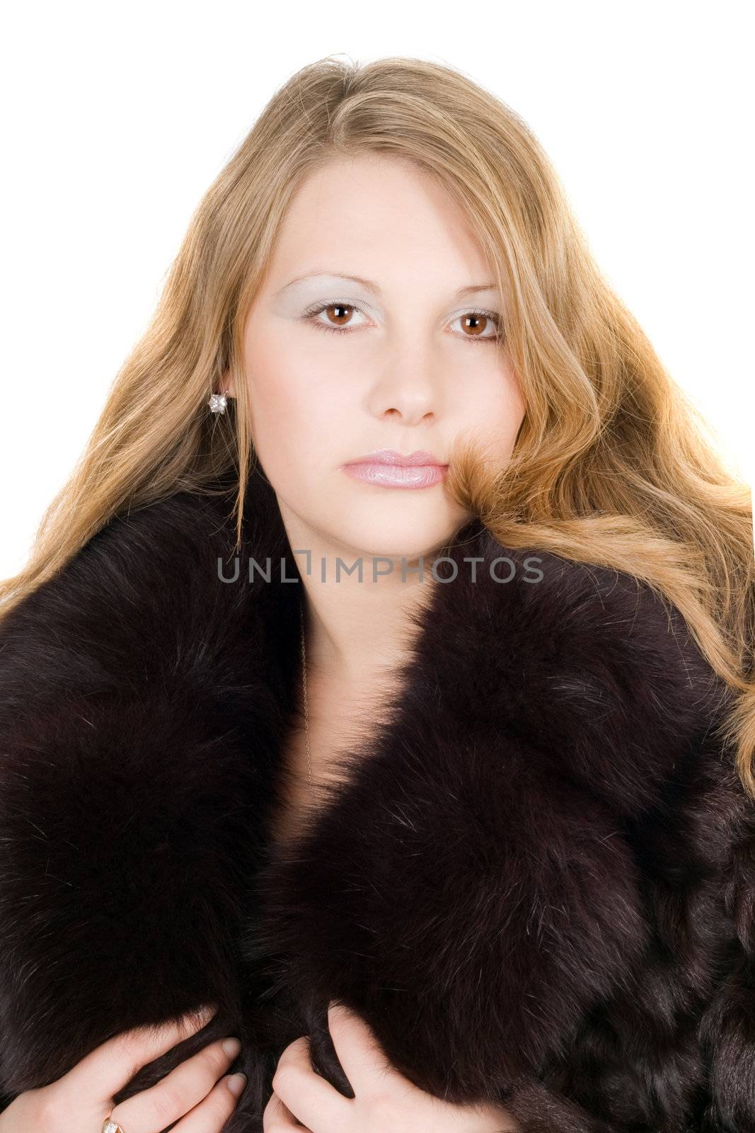 Portrait of the beautiful young lady in a fur coat