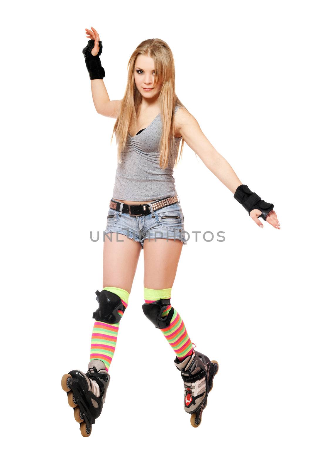 Pretty young woman tries to keep his balance on roller skates