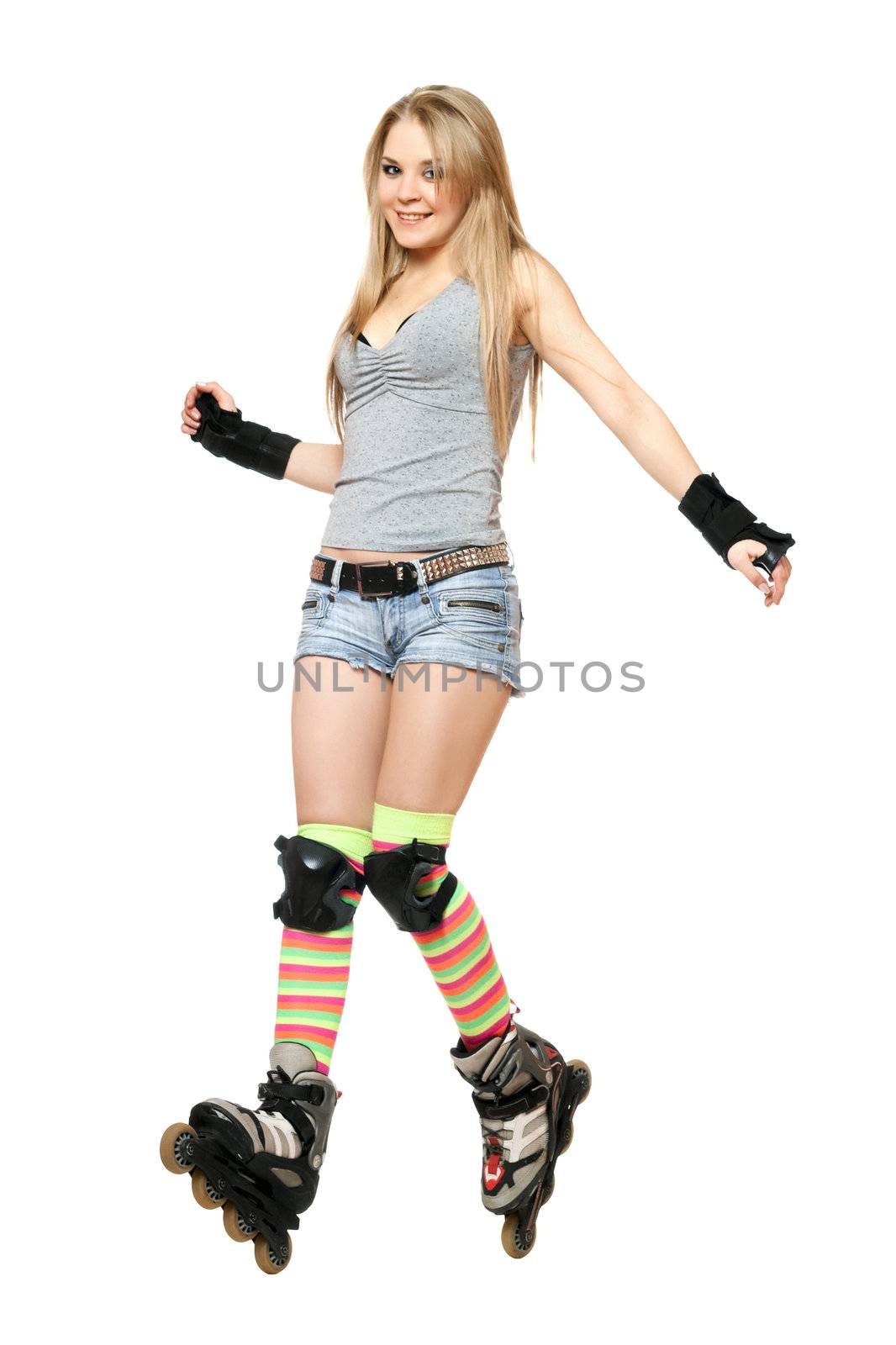 Cheerful young woman tries to keep his balance on roller skates