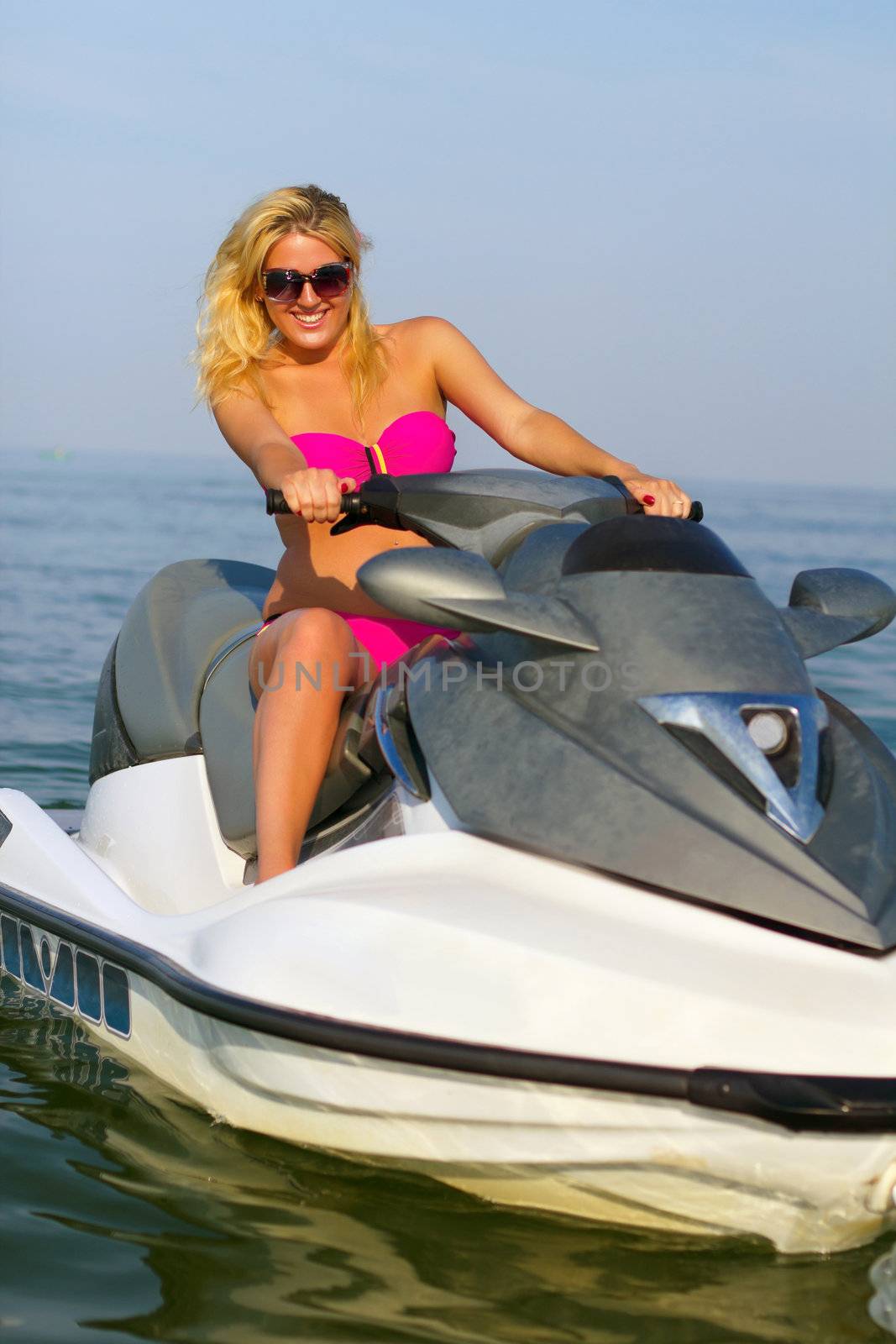 Beautiful smiling young woman on a jet ski