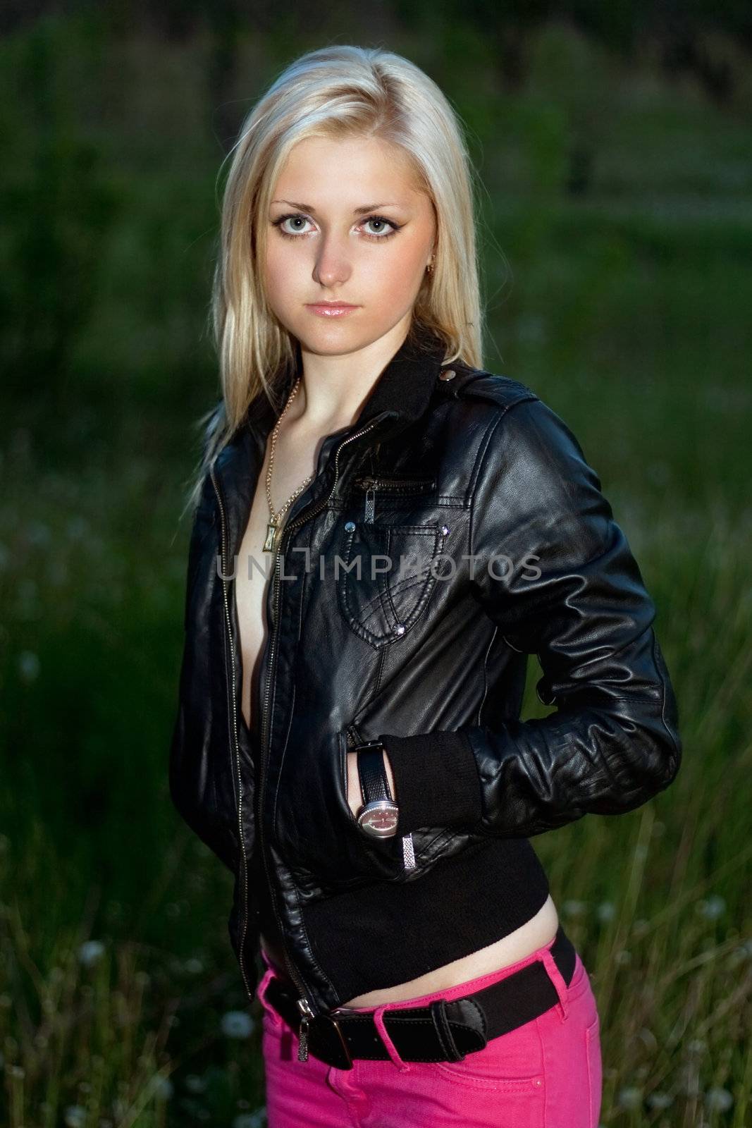 Young lovely blonde in a black leather jacket