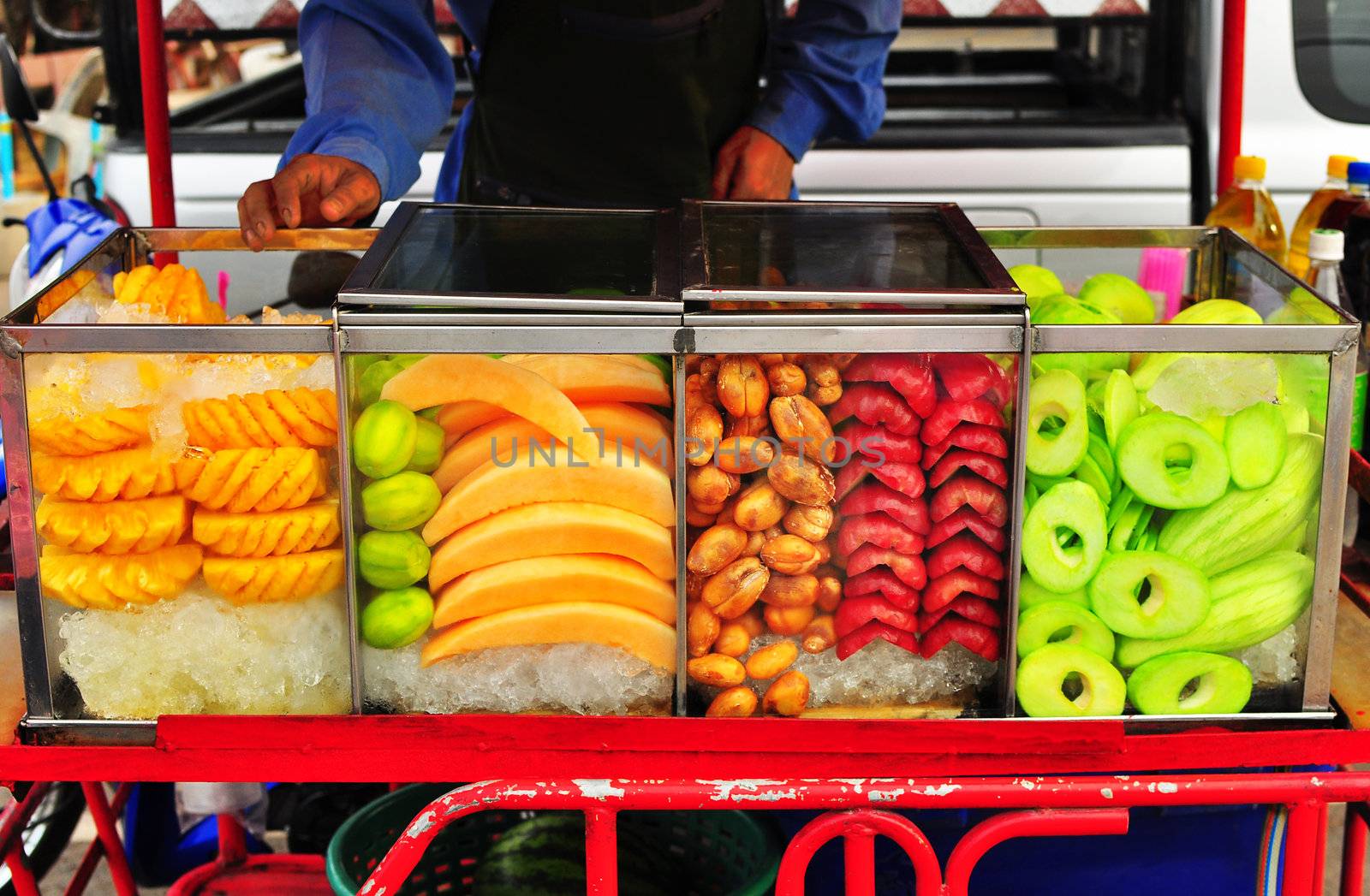 Varity of topical fruit in glass box install on fruit seller cart