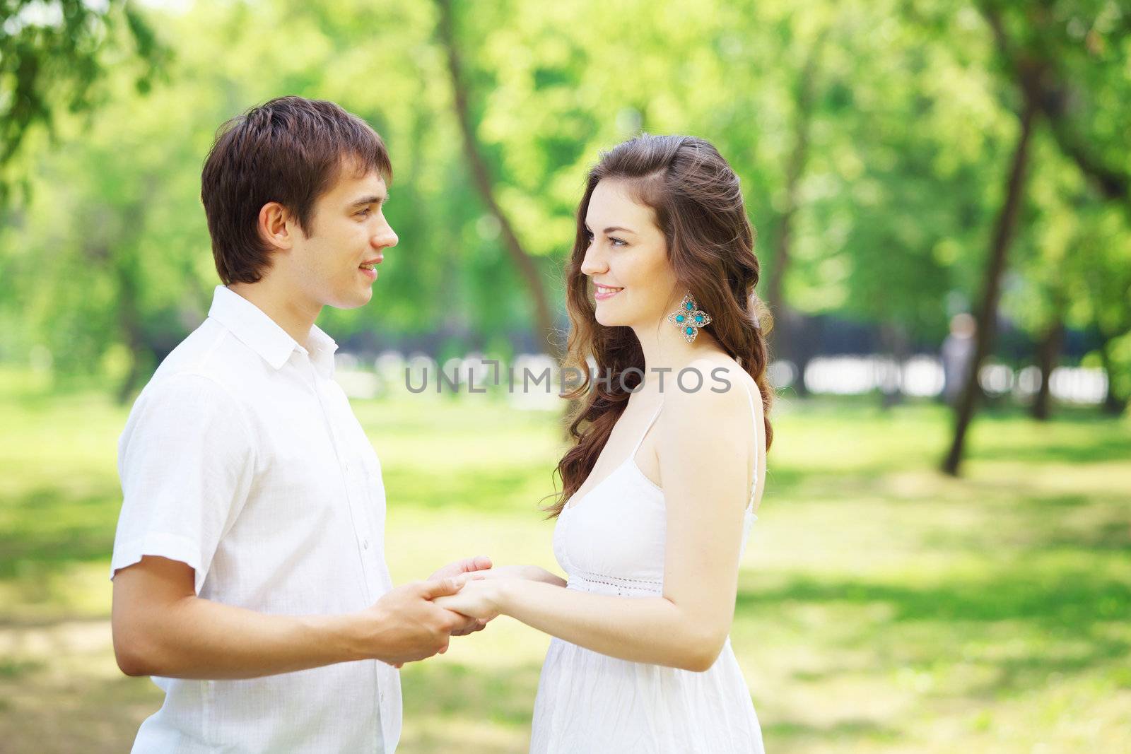 Young love Couple smiling under blue sky by sergey_nivens