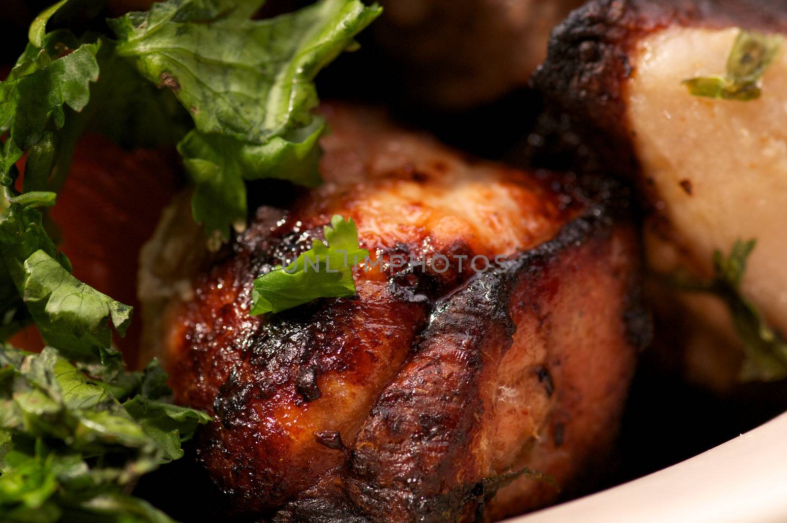 Portion of Perfect Ripe Pork Kebab closeup with Greens