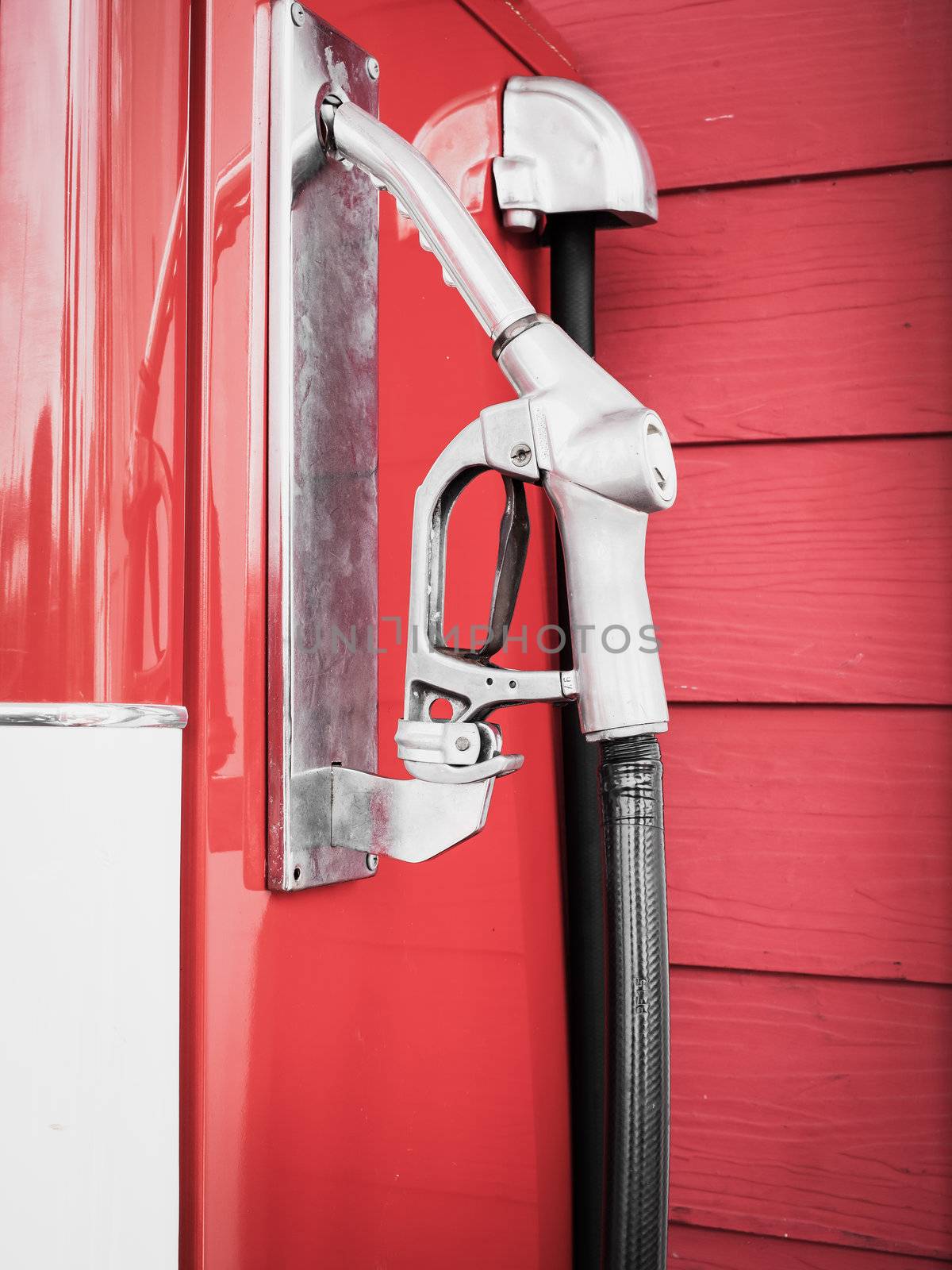 Gas pump nozzles in a service station by FrameAngel