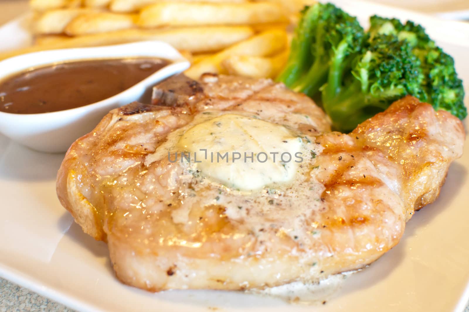 juicy grilled Pork chops and gravy with fried potato broccoli