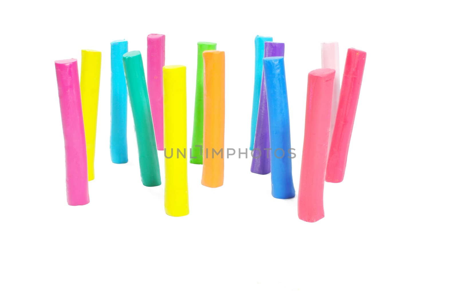 Colorful plasticine stick stand on white background