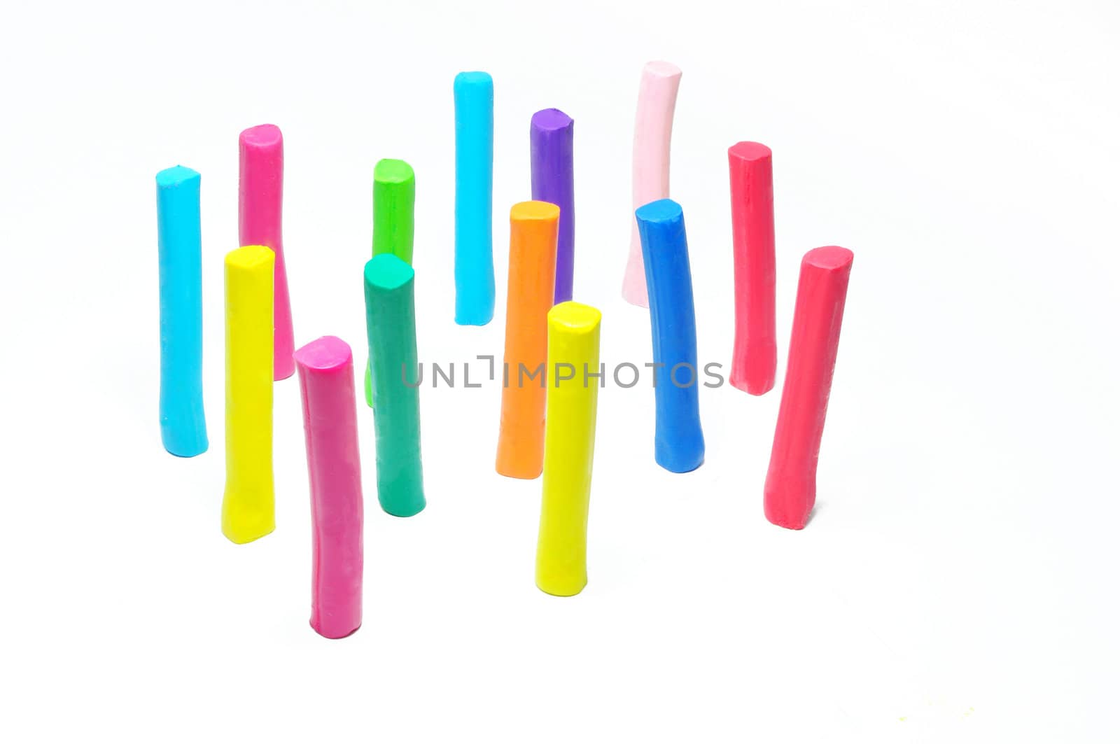 Colorful plasticine stick stand on white background