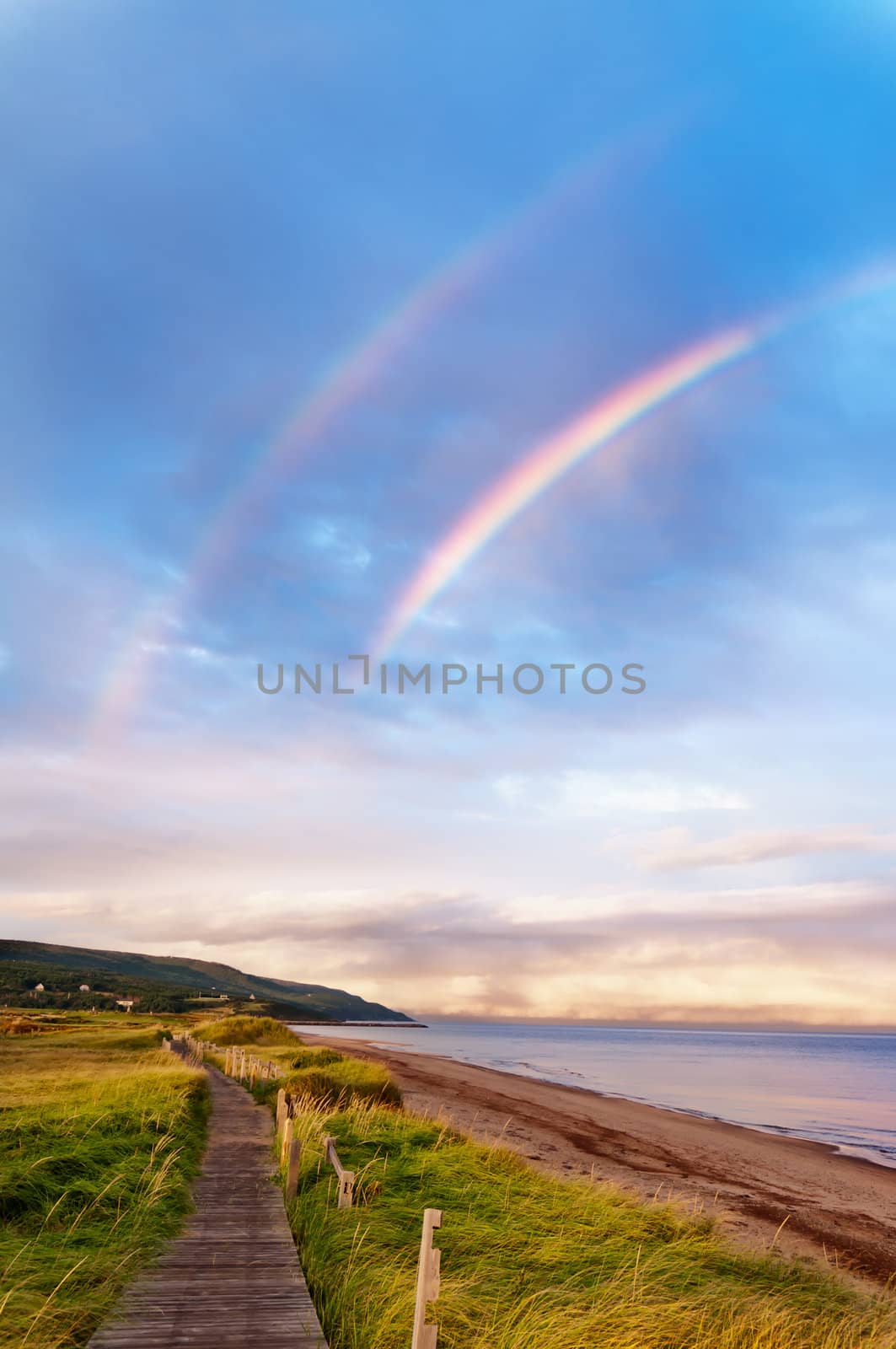 Sunrise at a beach with double rainbow by 3523Studio