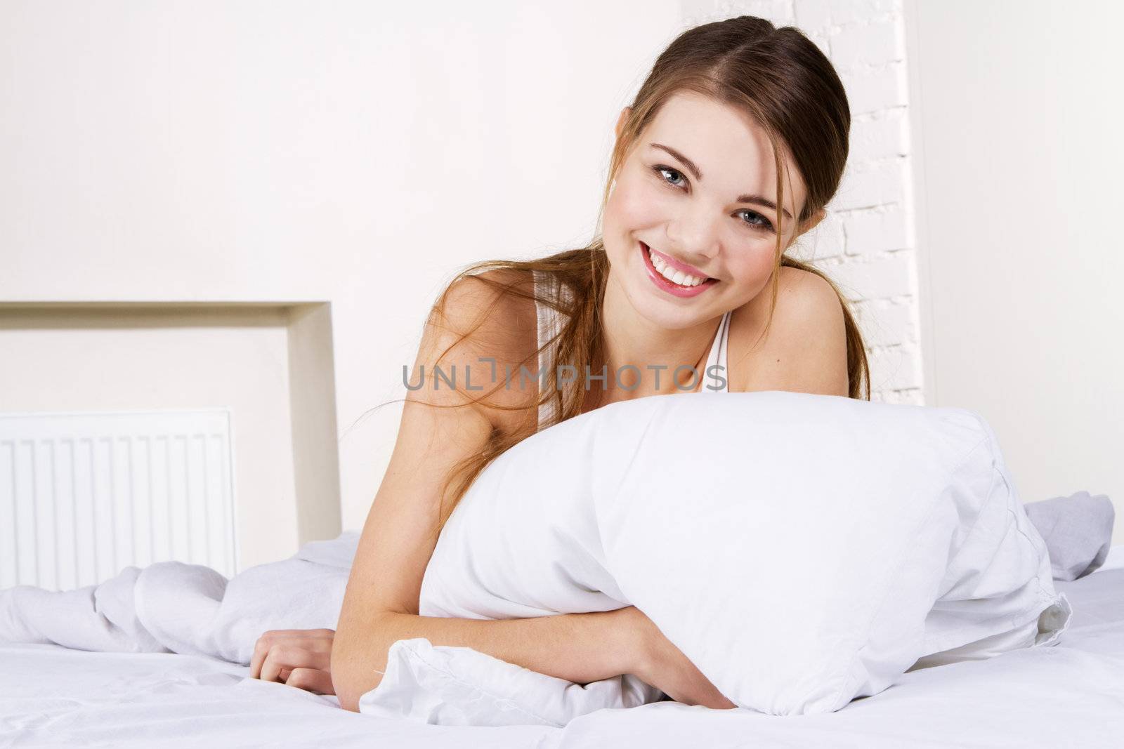 Young beautiful woman lying in bed 