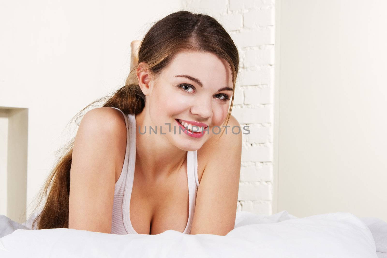 Young beautiful woman lying in bed 