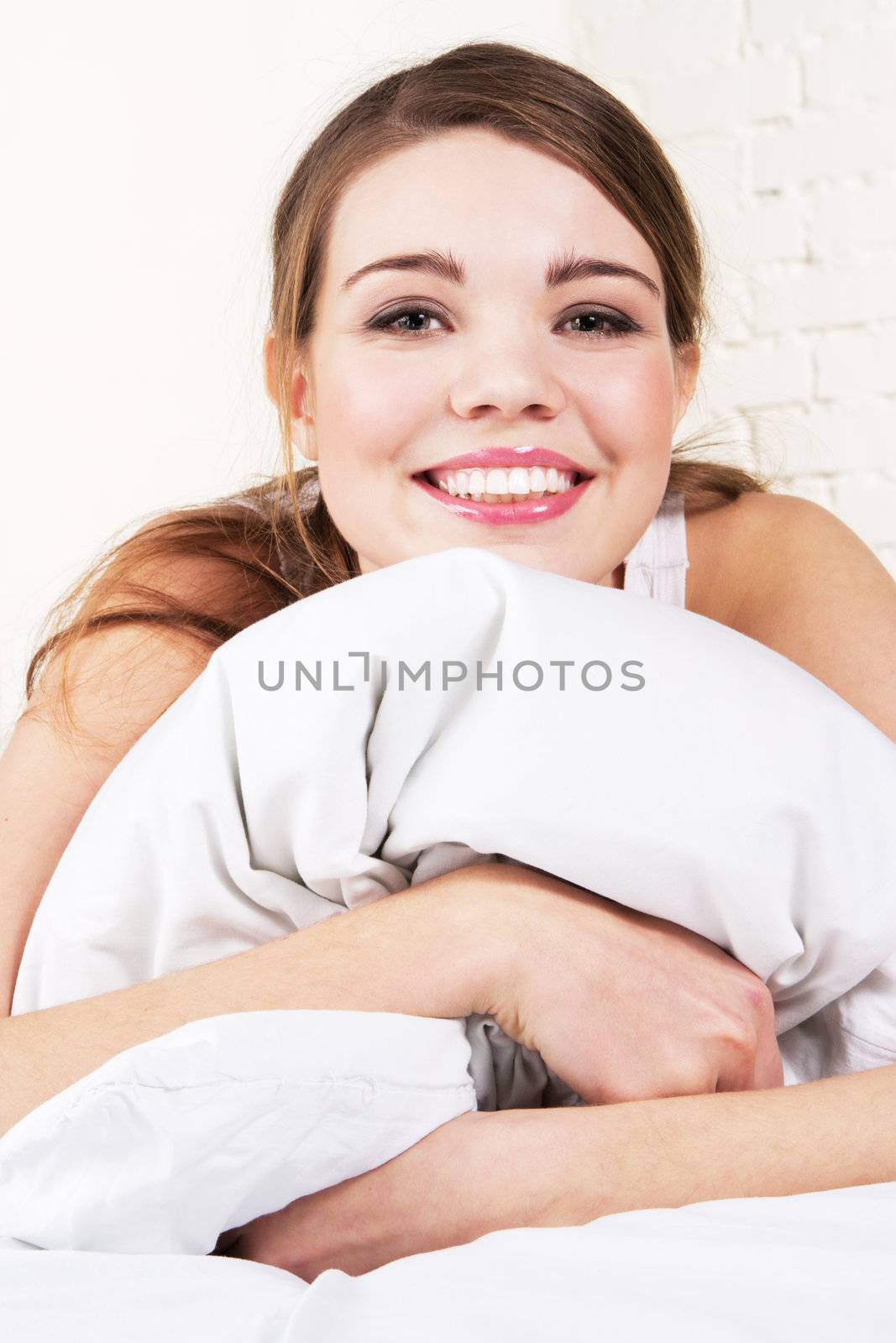 Young beautiful woman lying in bed 