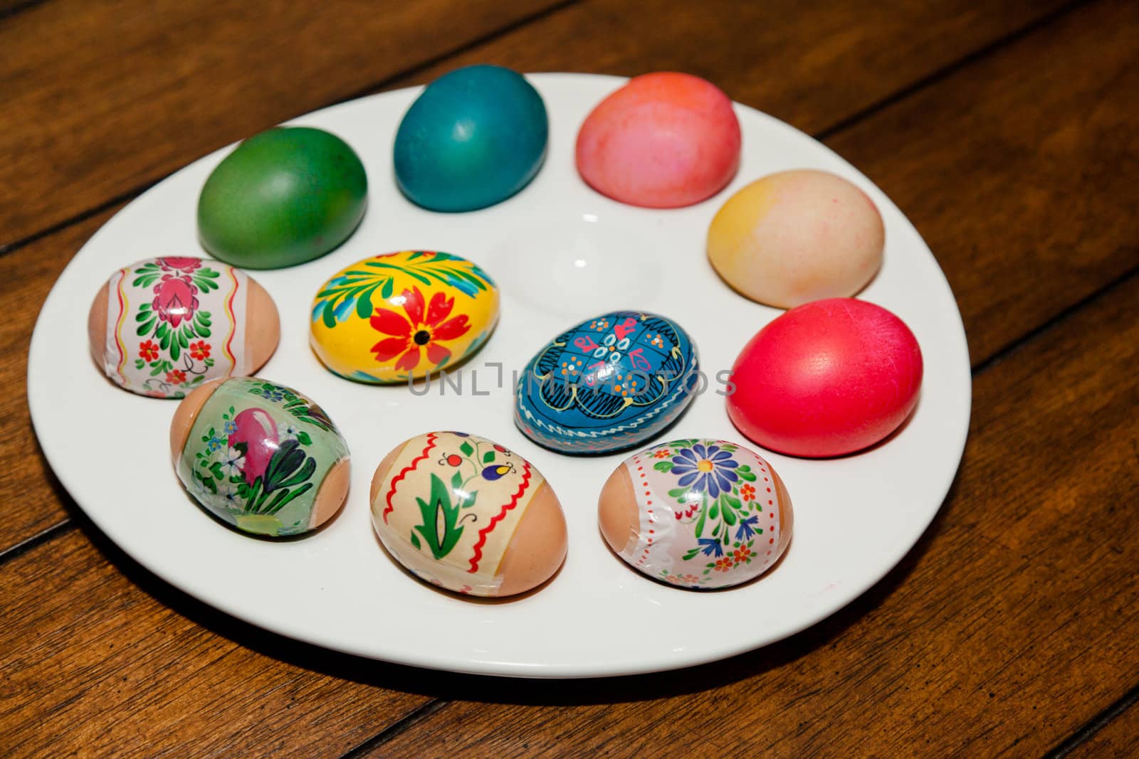 Colorful dyed Easter eggs on a while egg tray.