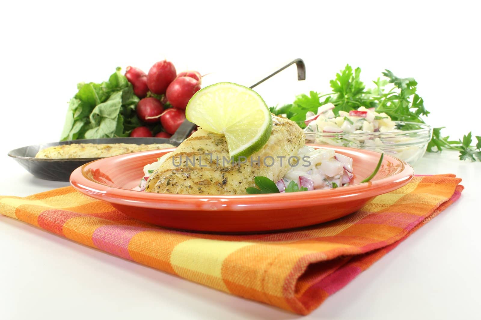 hake with lime on potato salad and chives