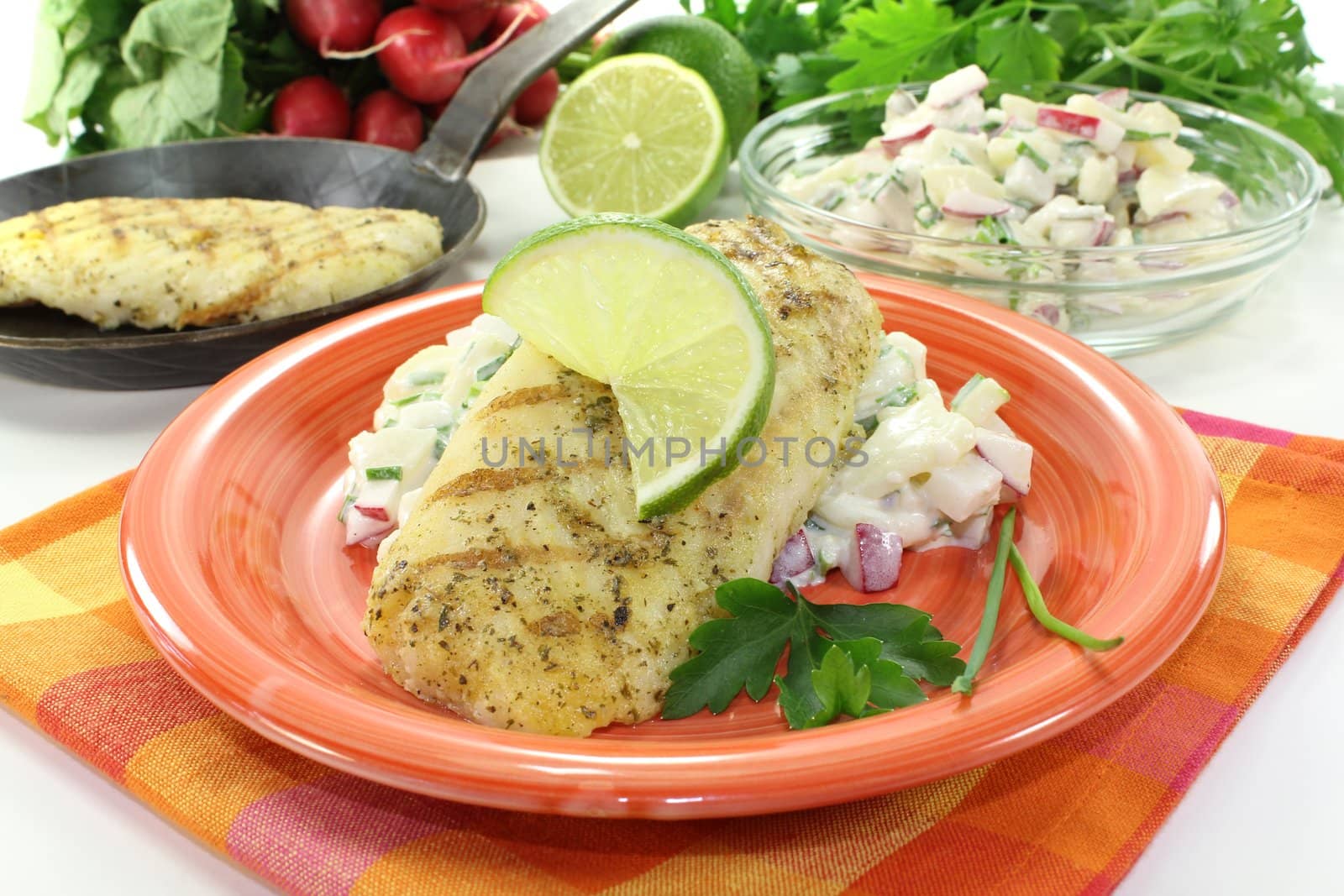 hake with lime on potato salad and parsley