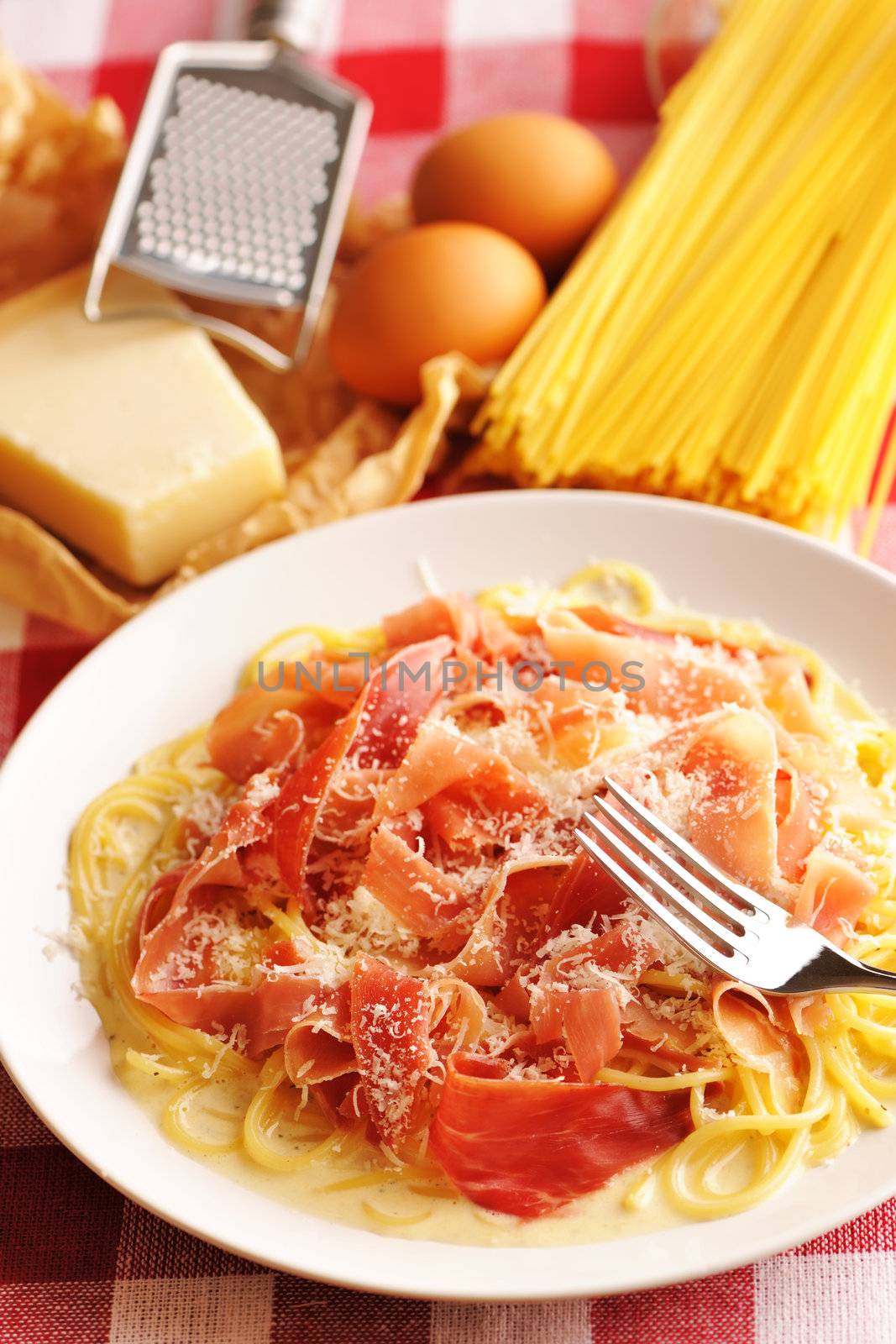 Pasta carbonara over red cloth